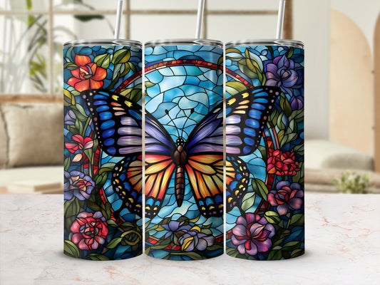 Stained glass butterfly and floral design on a cylindrical tumbler.