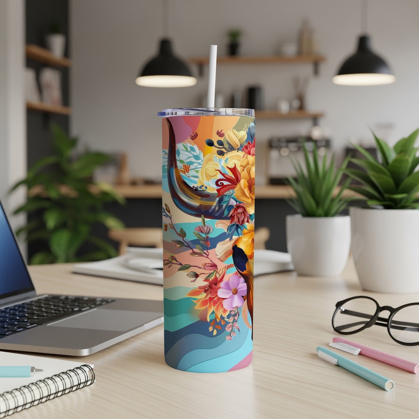Tall tumbler with colorful abstract floral and bull head design.
