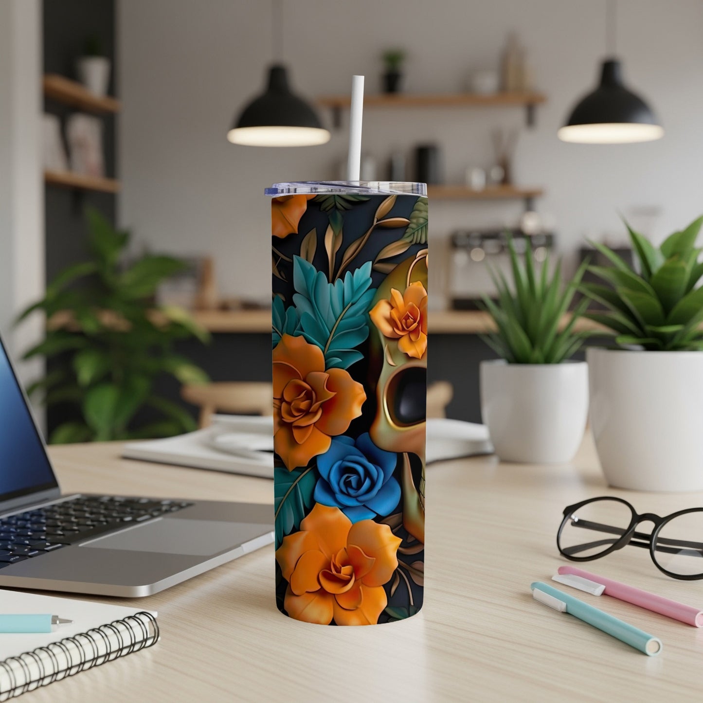 Tumbler with skull and floral design, featuring orange and blue flowers.