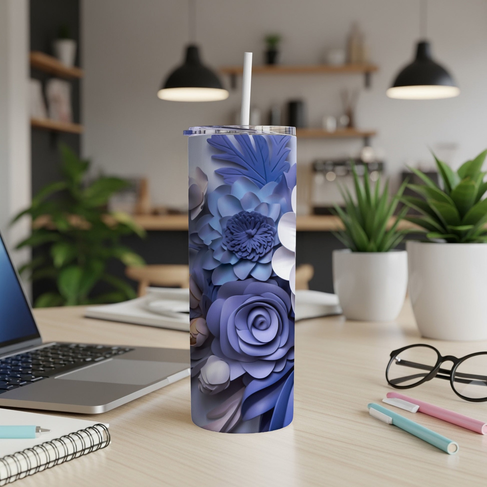 Purple floral skinny tumbler with straw on desk.