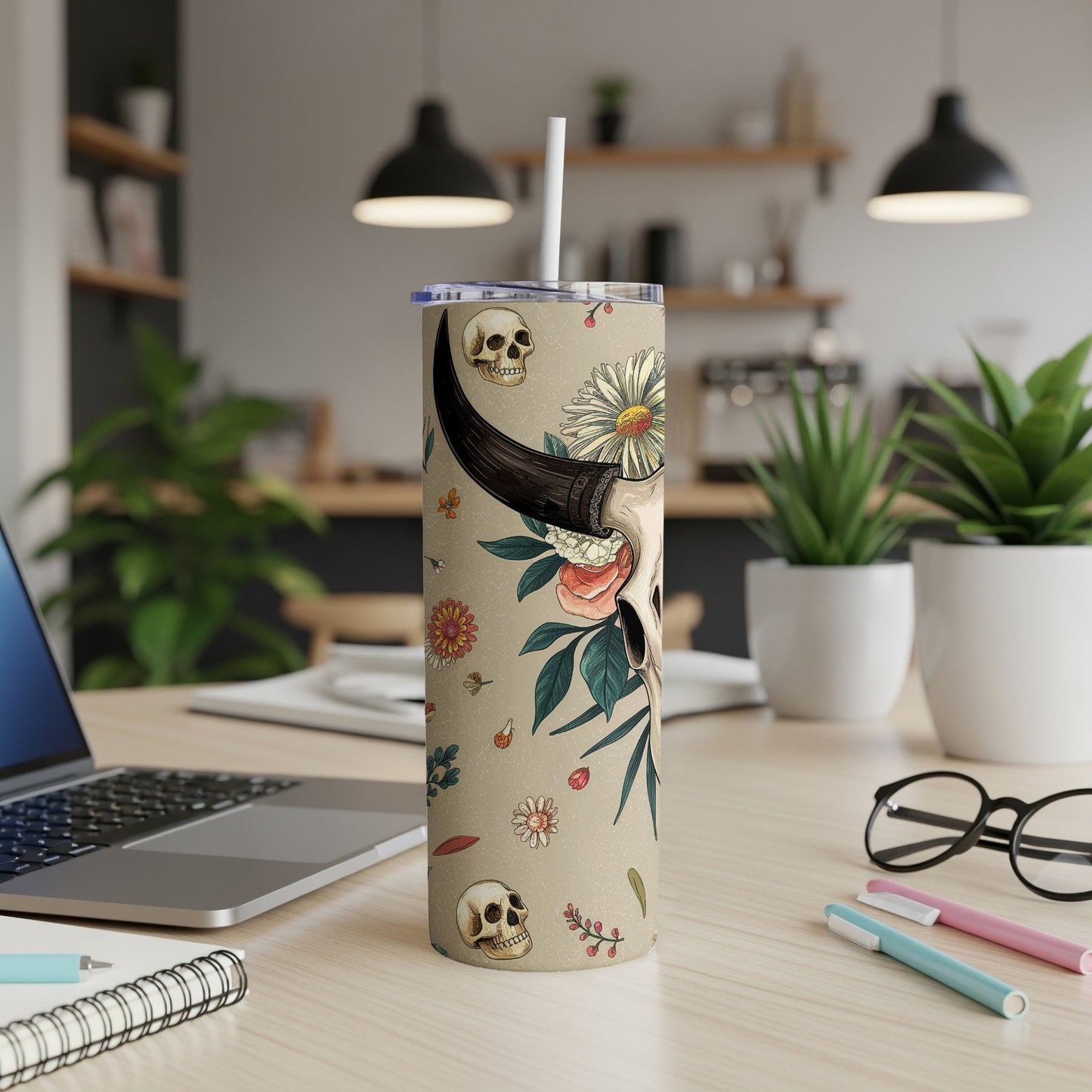 Tall tumbler with skull and floral design, featuring a bull skull graphic.