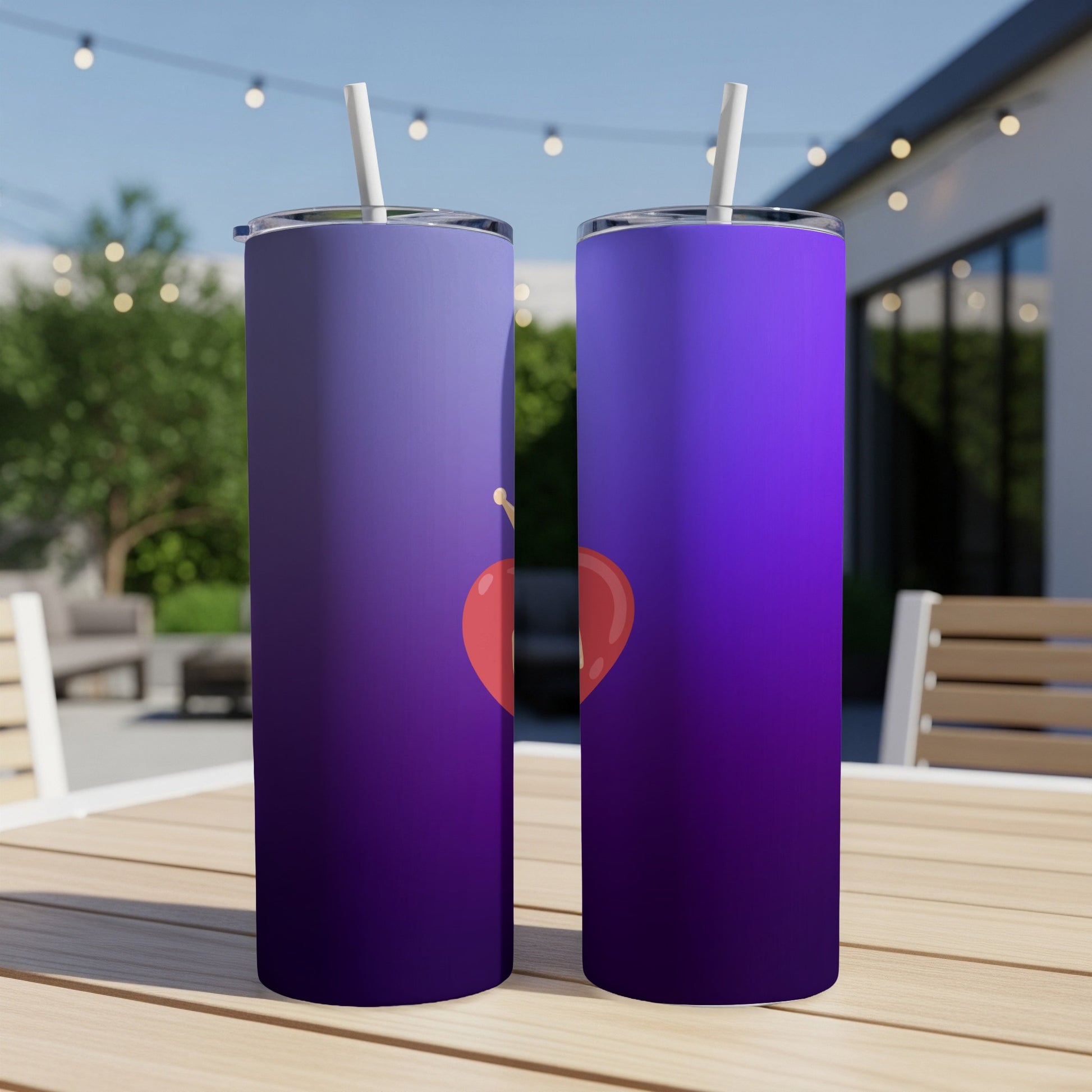 Two purple gradient tumblers with a red heart design and straw.