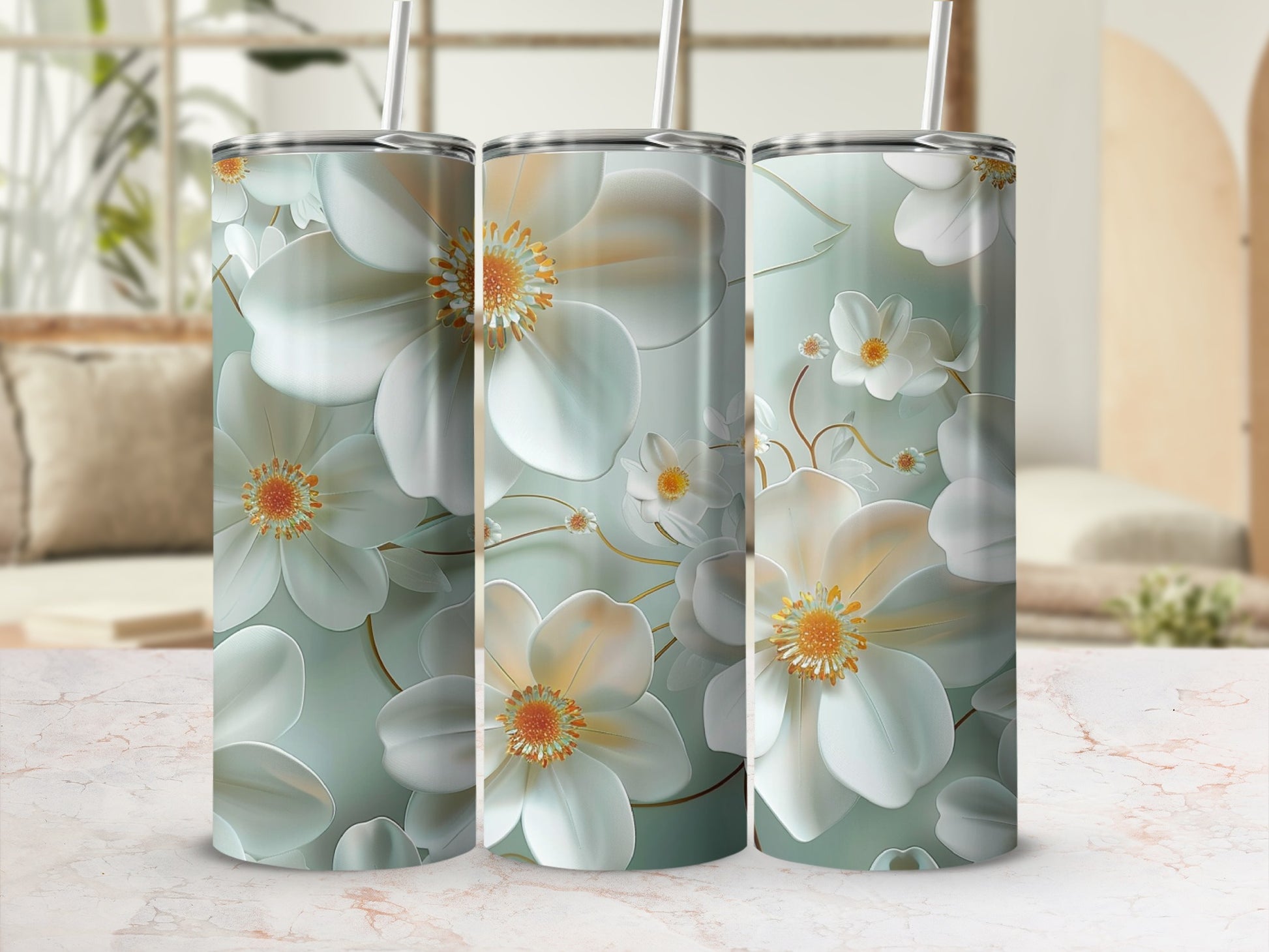 Three tall tumblers with a subtle floral design and straw.