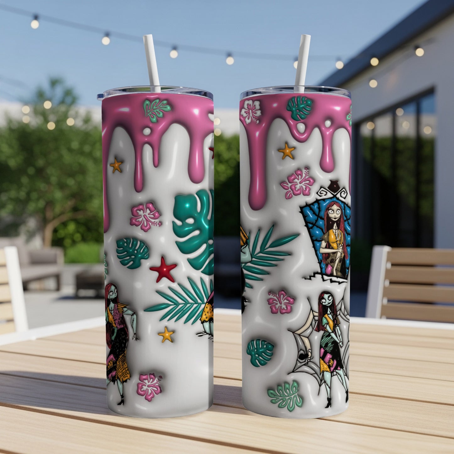 Two white tumblers with tropical leaves and characters from The Nightmare Before Christmas.