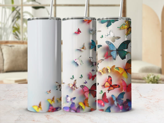 Three tumblers with colorful butterflies, one white, two patterned.