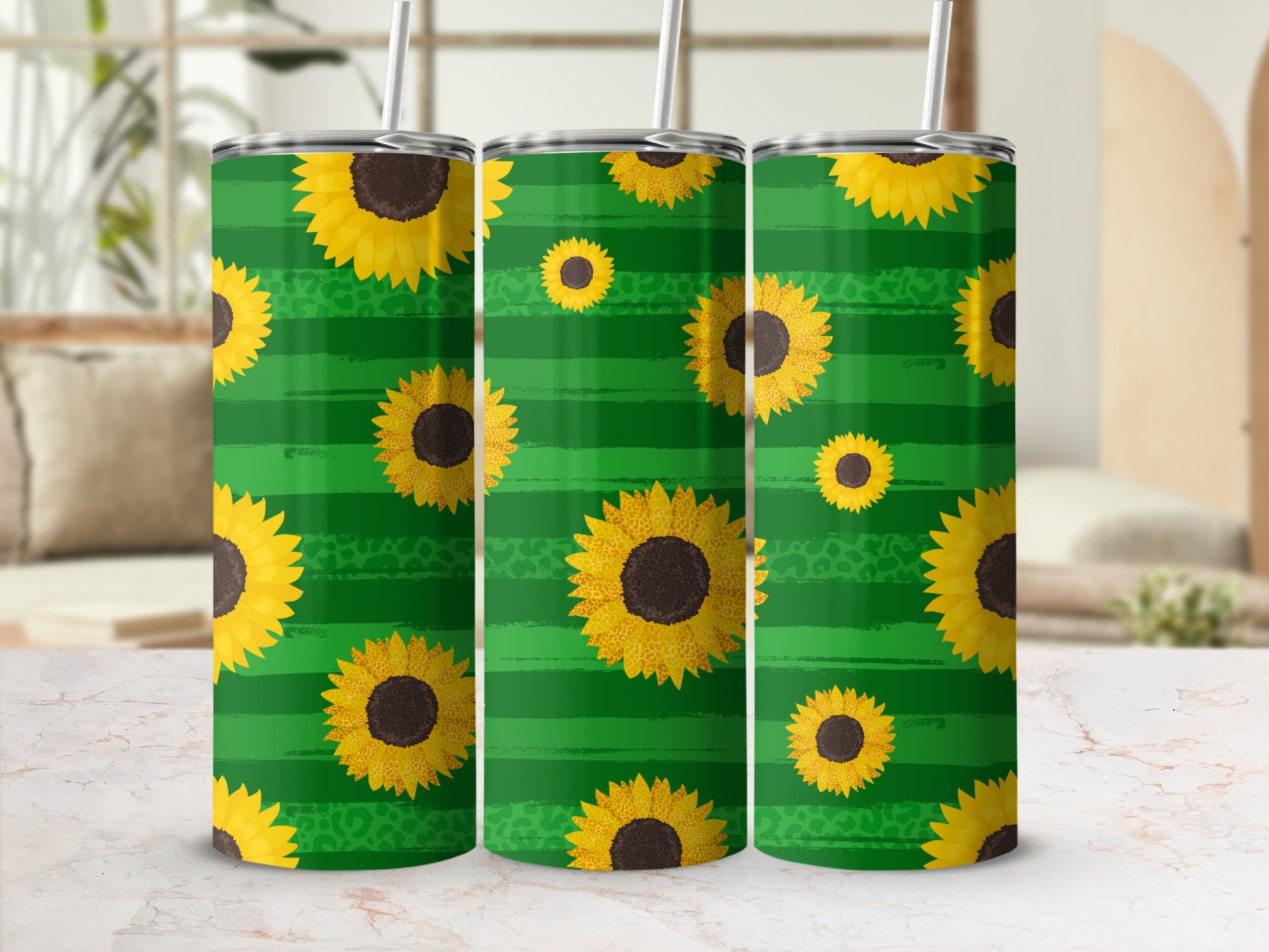 Green striped tumbler with sunflowers and a straw.
