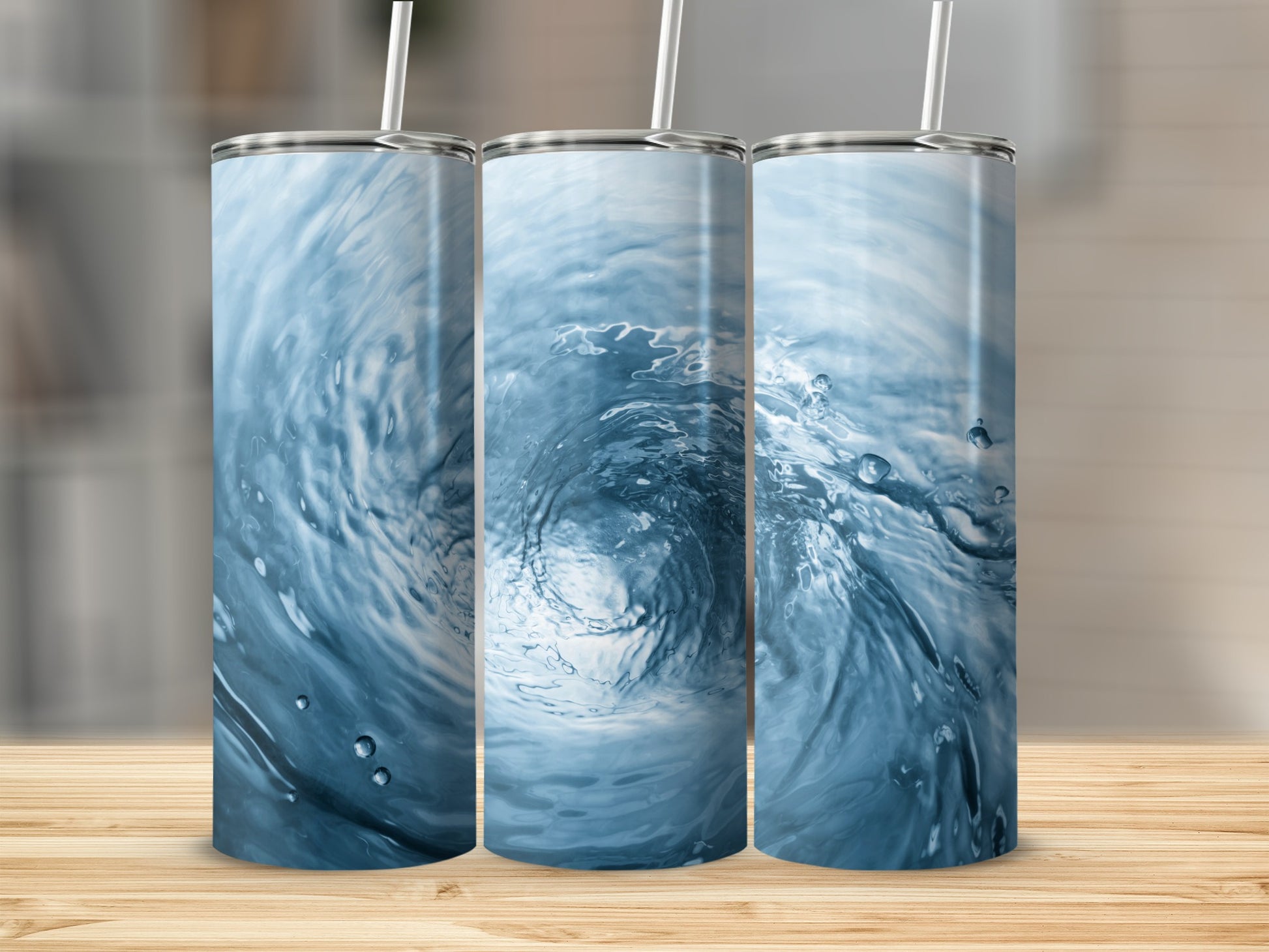Three tumblers with a swirling blue water vortex design.