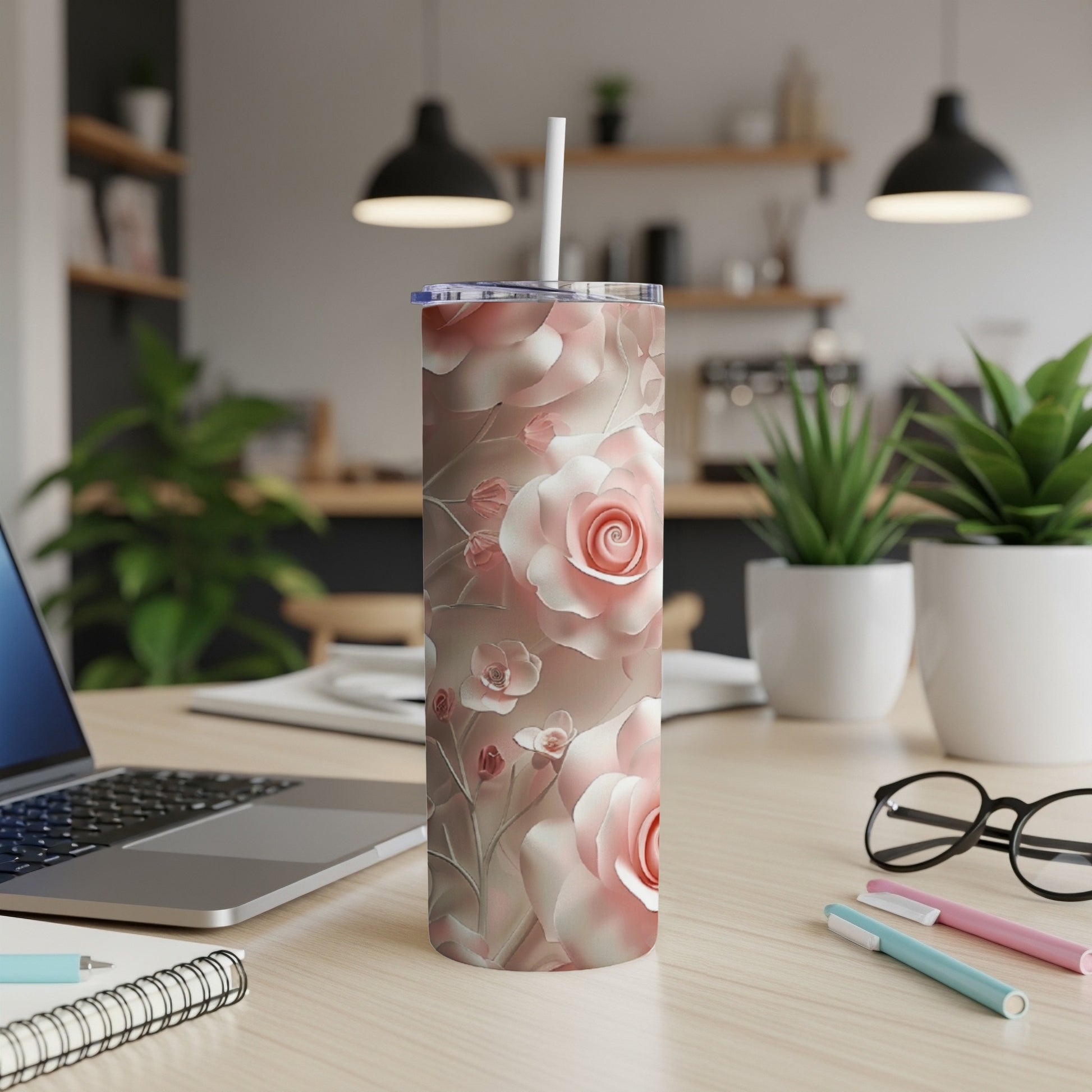 3D pink rose patterned tumbler with white straw on a desk.