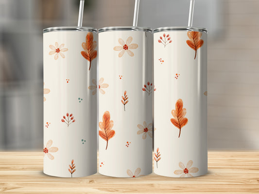 Cream tumbler with autumn leaves and floral watercolor pattern.