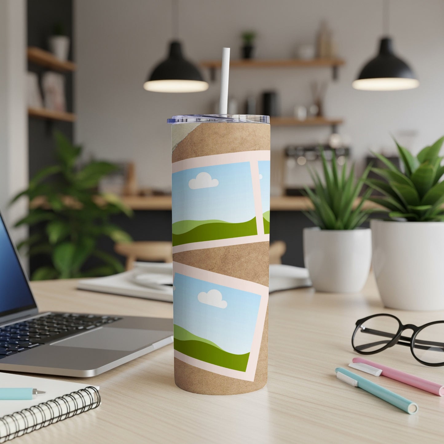 Tumbler with a collage of landscape photos on a desk.