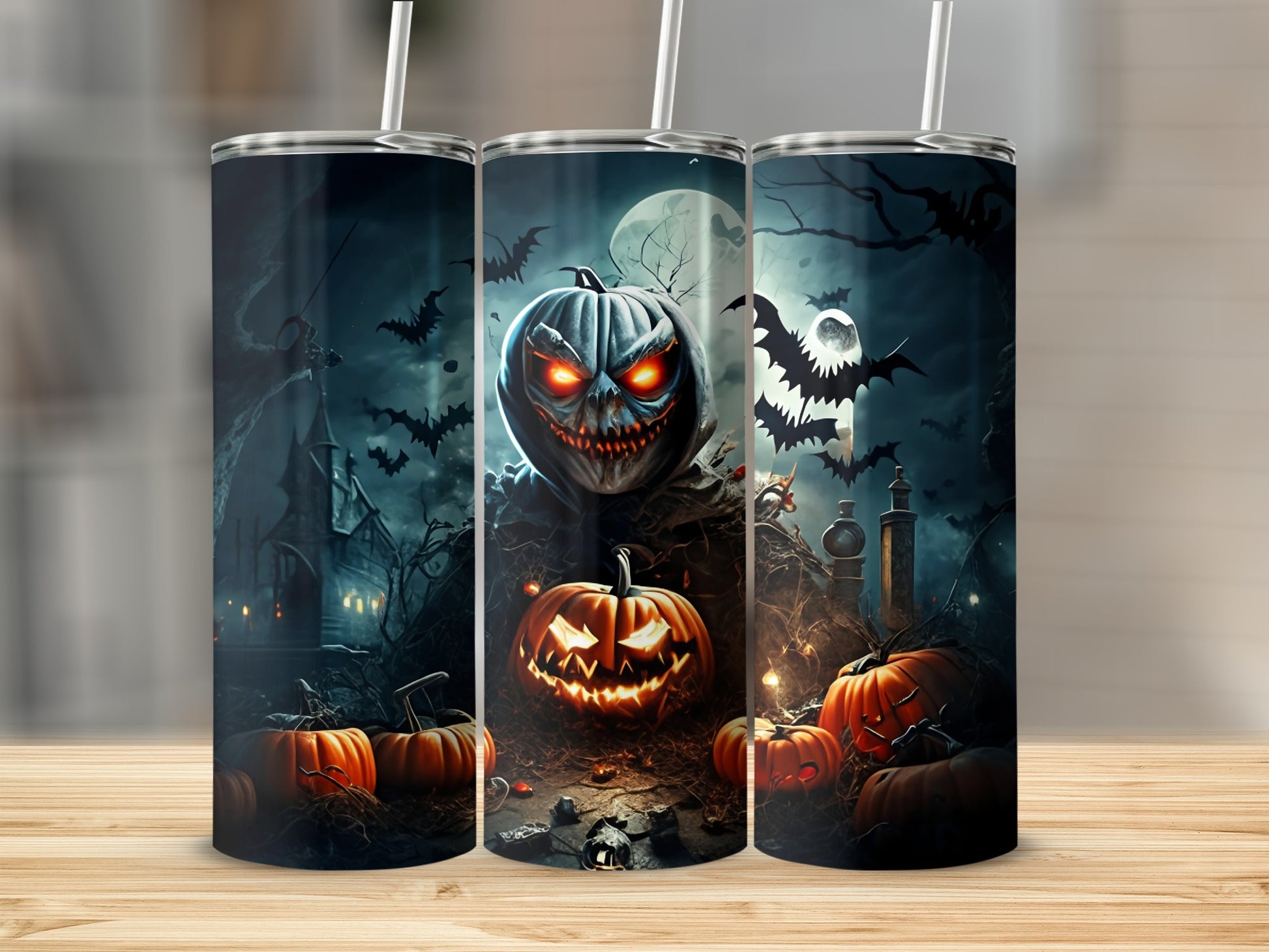 Three tumblers with spooky Halloween designs featuring pumpkins, bats, and a haunted castle.