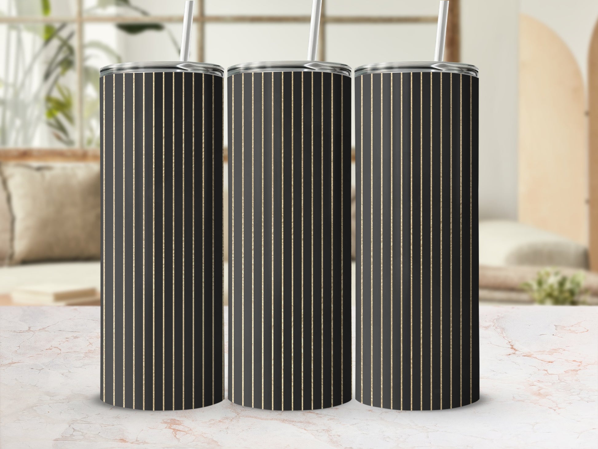 Three tumblers with black and thin gold vertical stripes, each with a silver lid and straw.