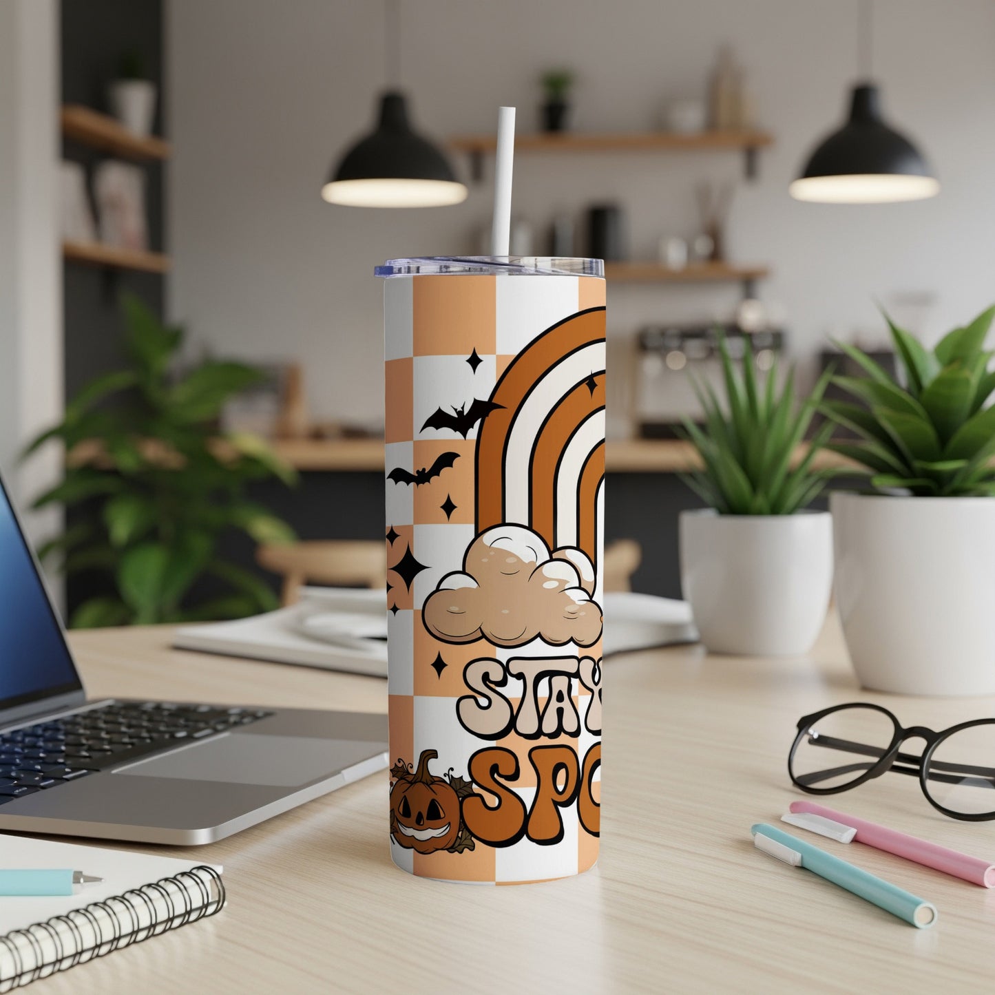 Tumbler with orange checkerboard, rainbow, clouds, bats, pumpkin, and "Stay Spooky" text.