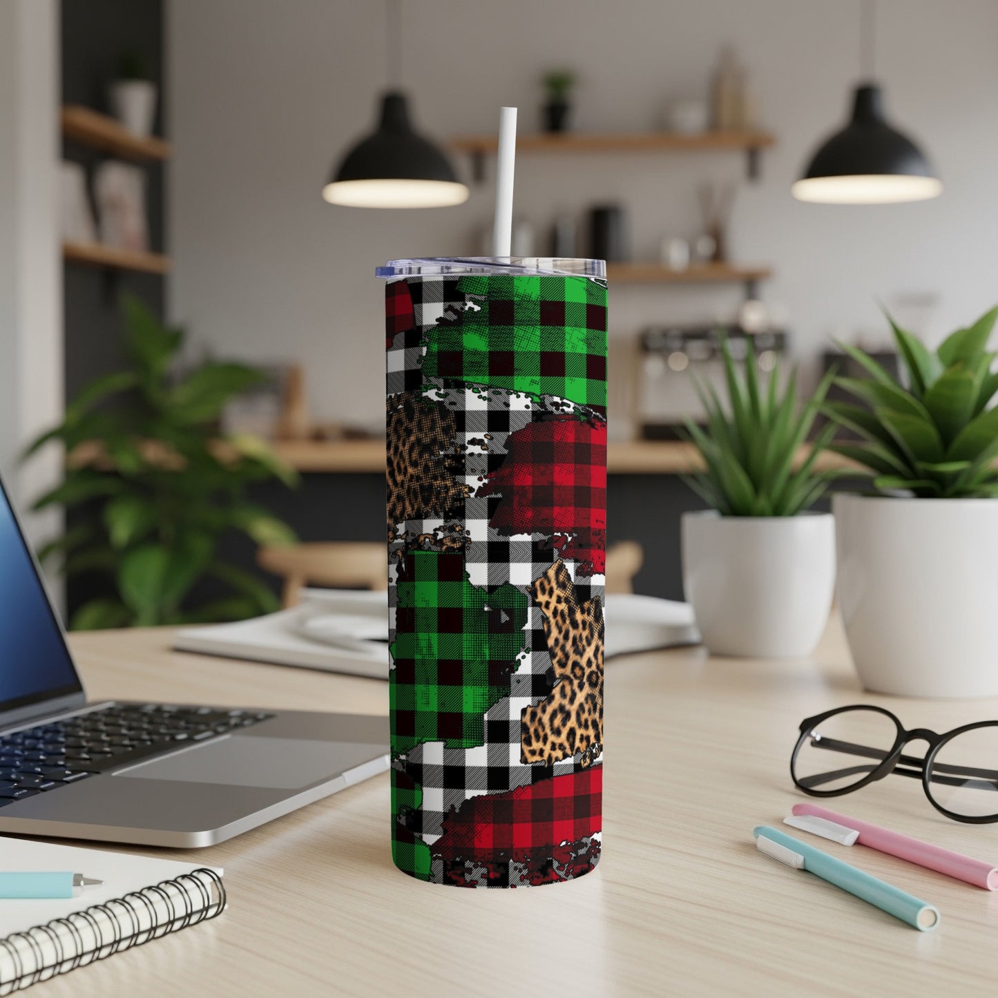 Christmas plaid and leopard print skinny tumbler on desk.