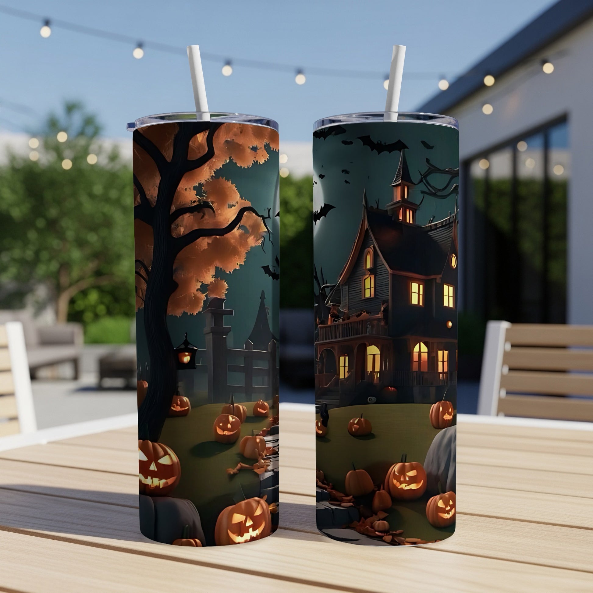 Two tumblers featuring a Halloween scene with a haunted house, jack-o'-lanterns, and bats.