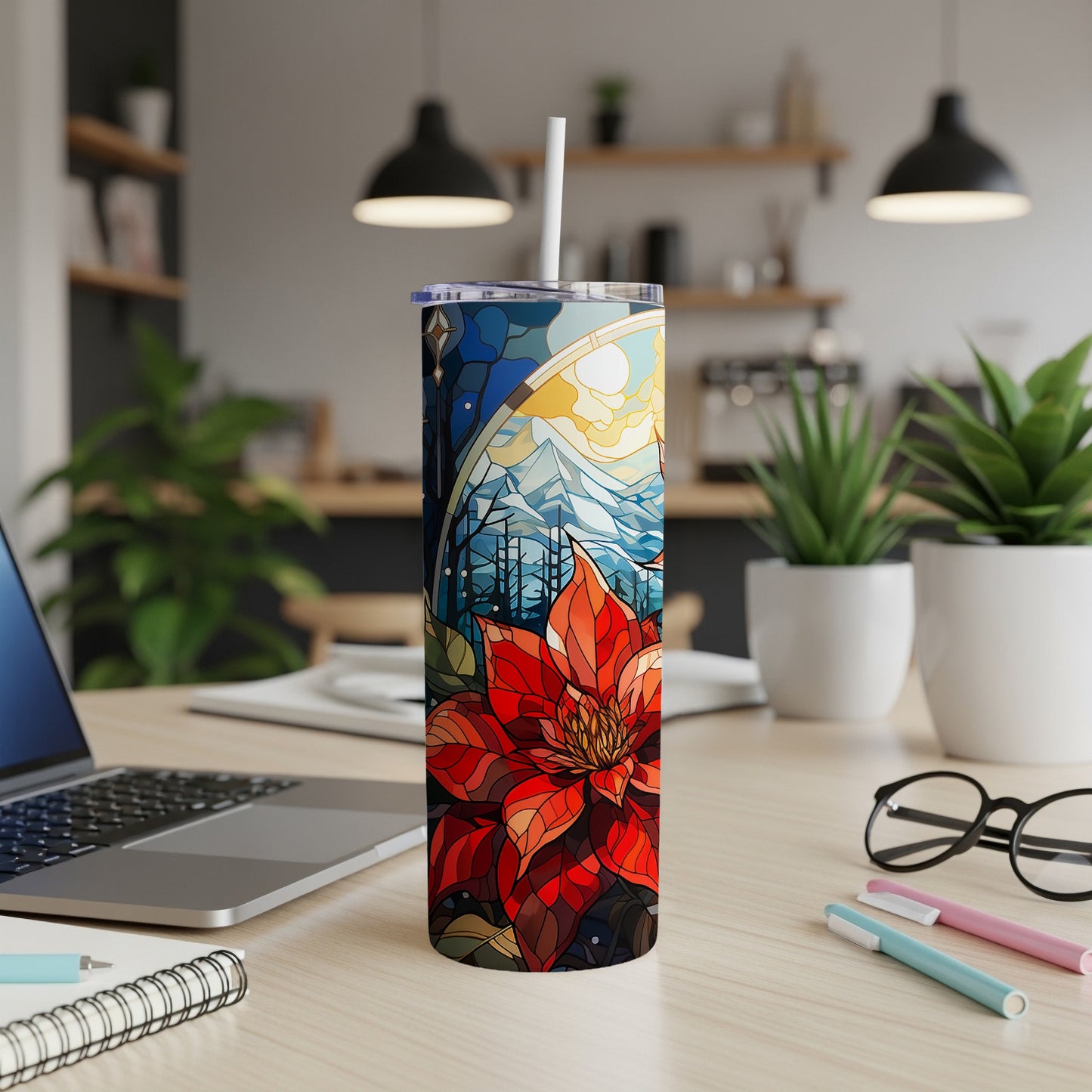 Stained glass poinsettia and winter mountain scene on a white tumbler.