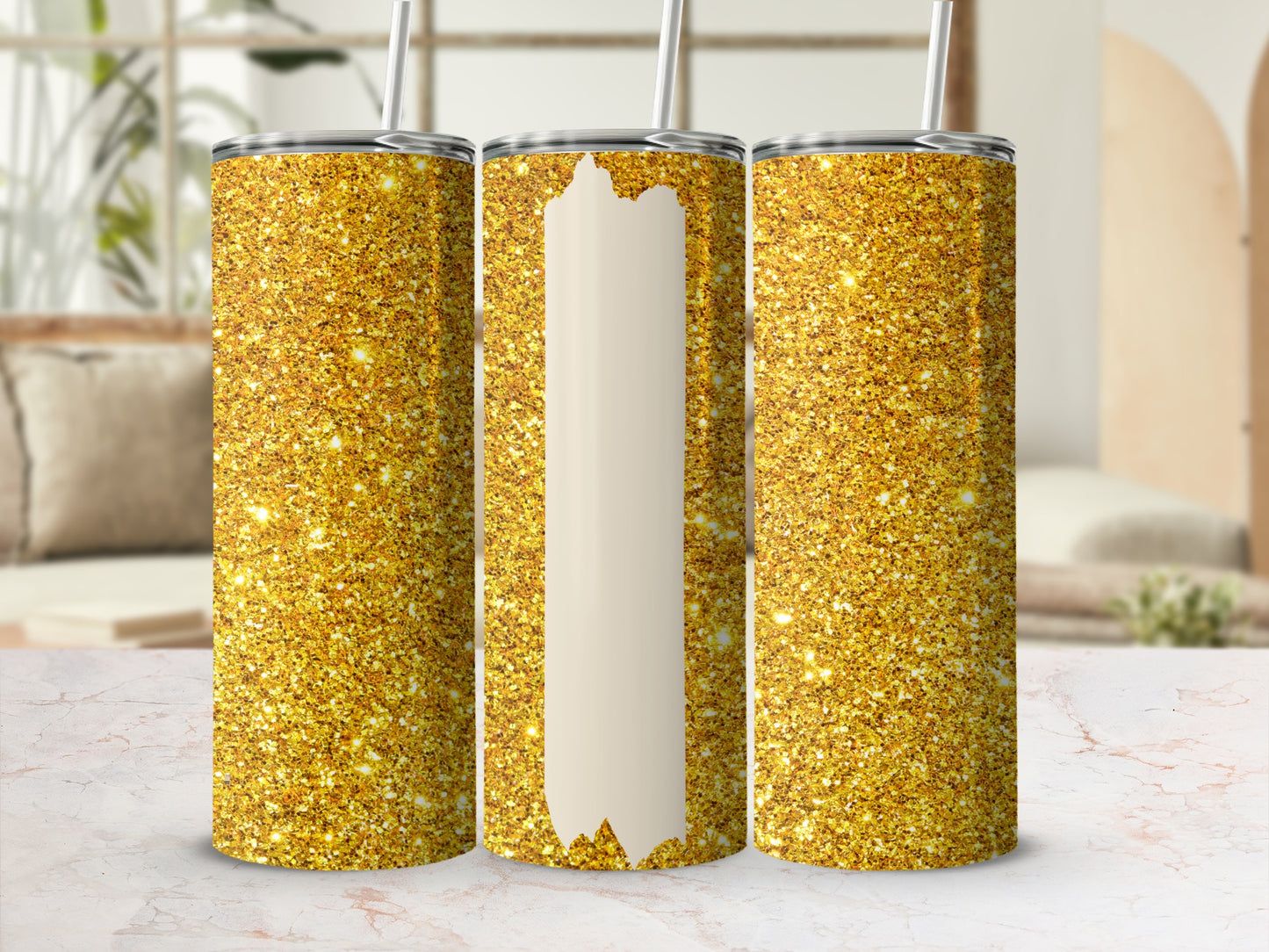 Three glittery gold tumblers with white sections, displayed on a marbled surface.