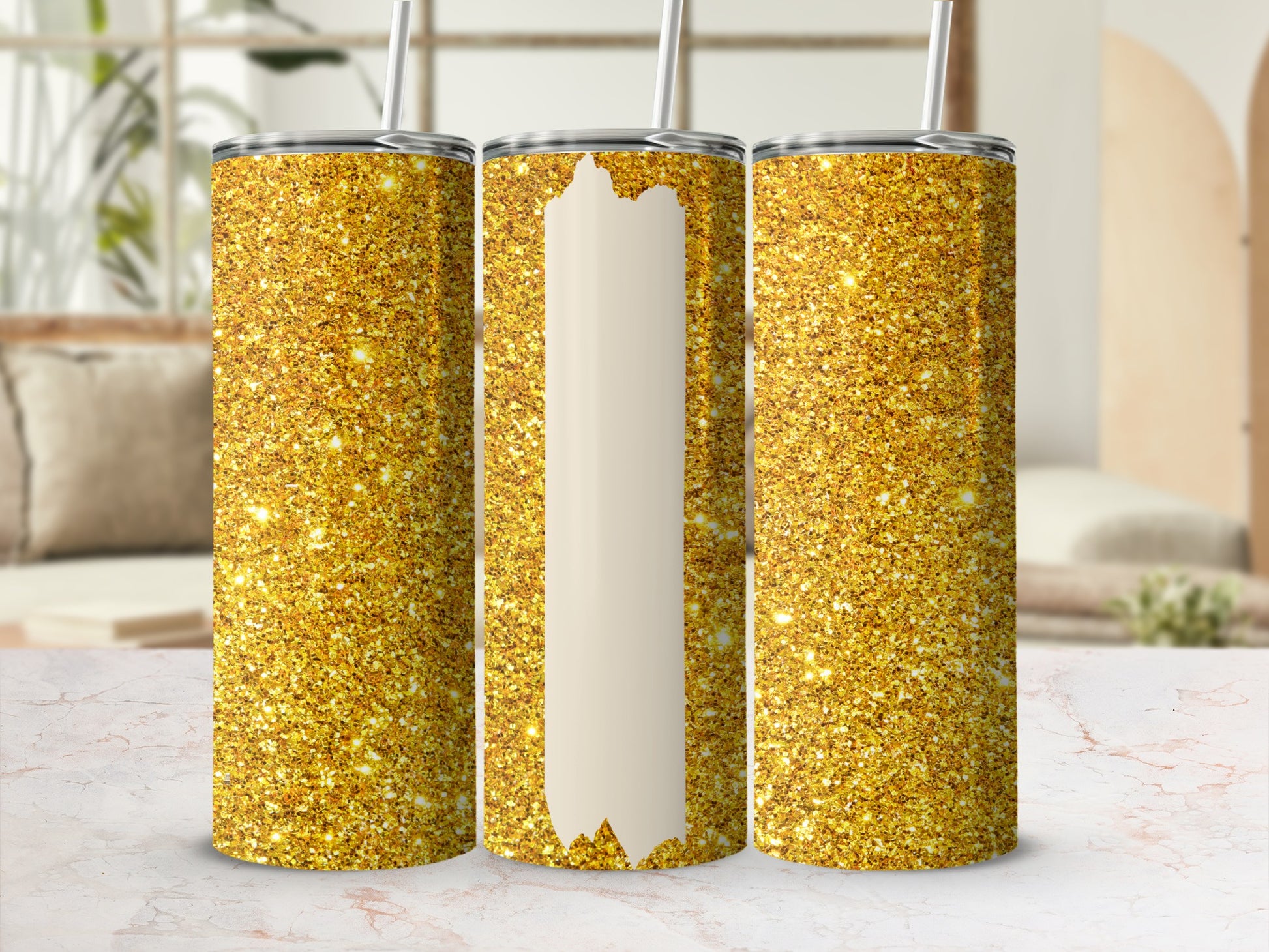 Three glittery gold tumblers with white sections, displayed on a marbled surface.