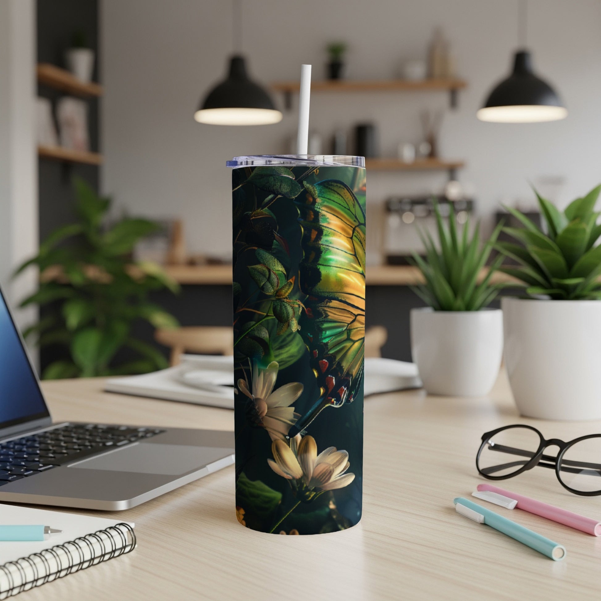 Butterfly and flowers on a stainless steel tumbler with a straw.