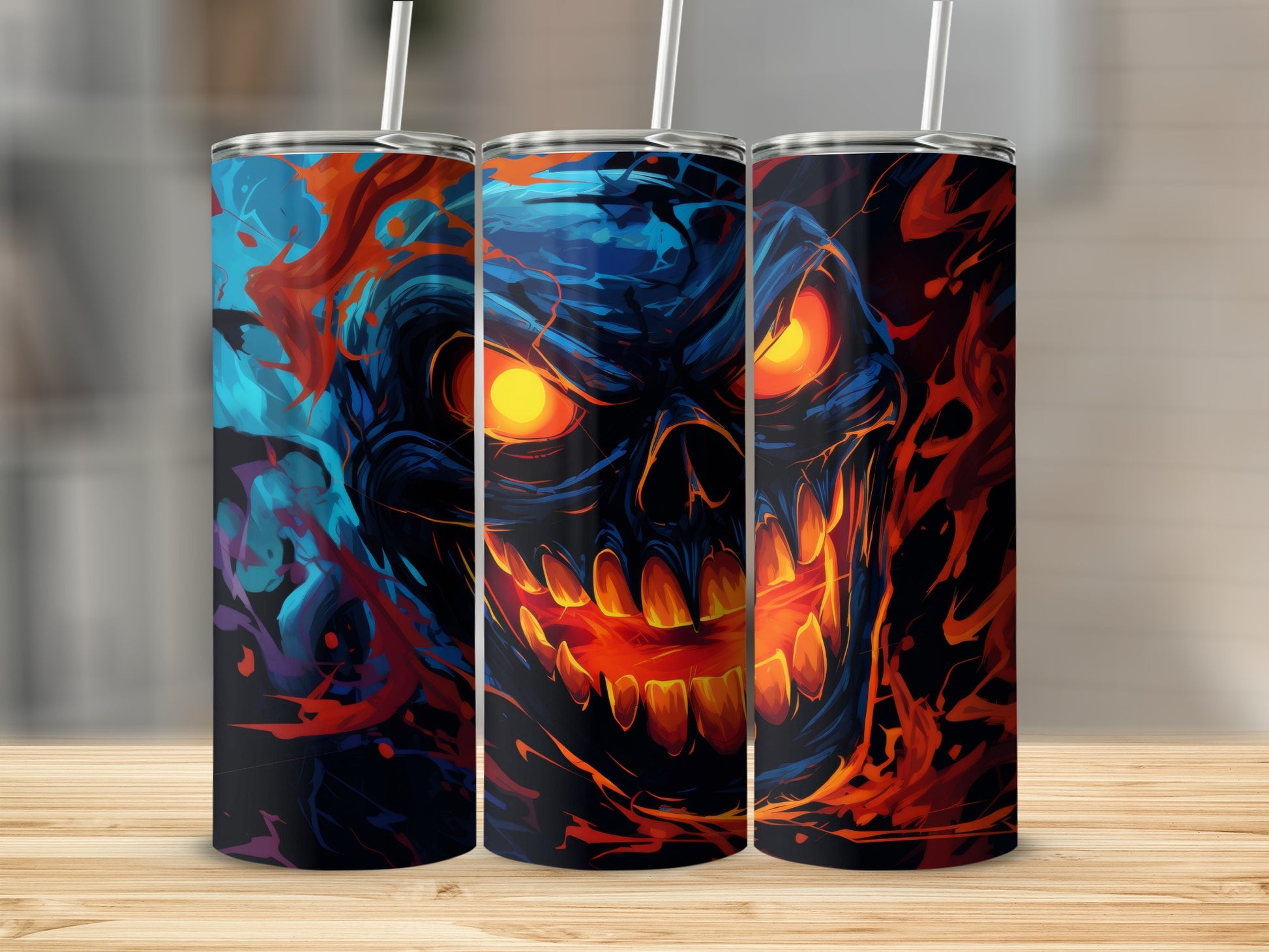 Three tumblers featuring a stylized, fiery skull design with glowing eyes.