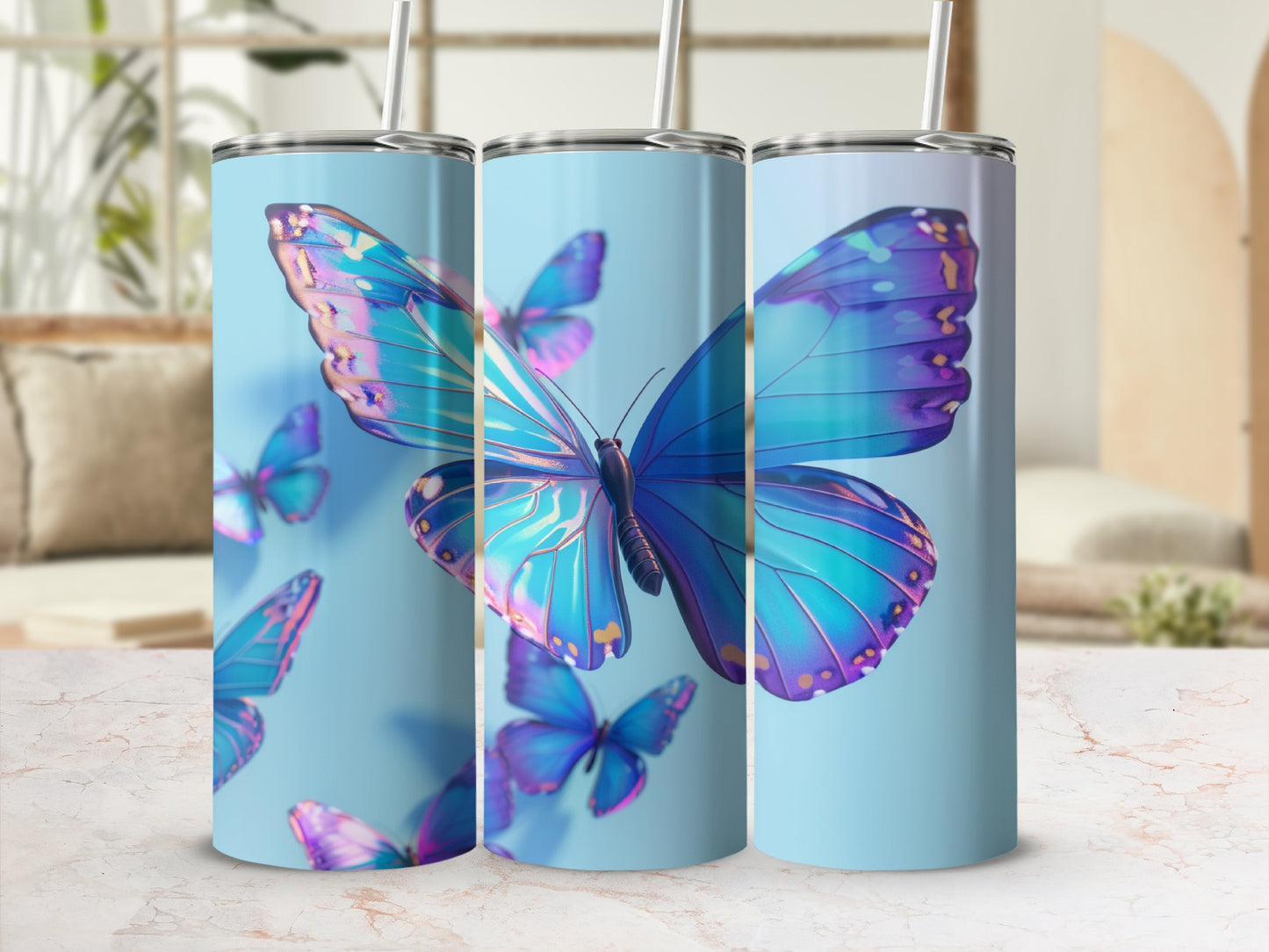Blue and purple butterflies adorn three light blue tumblers with straws.