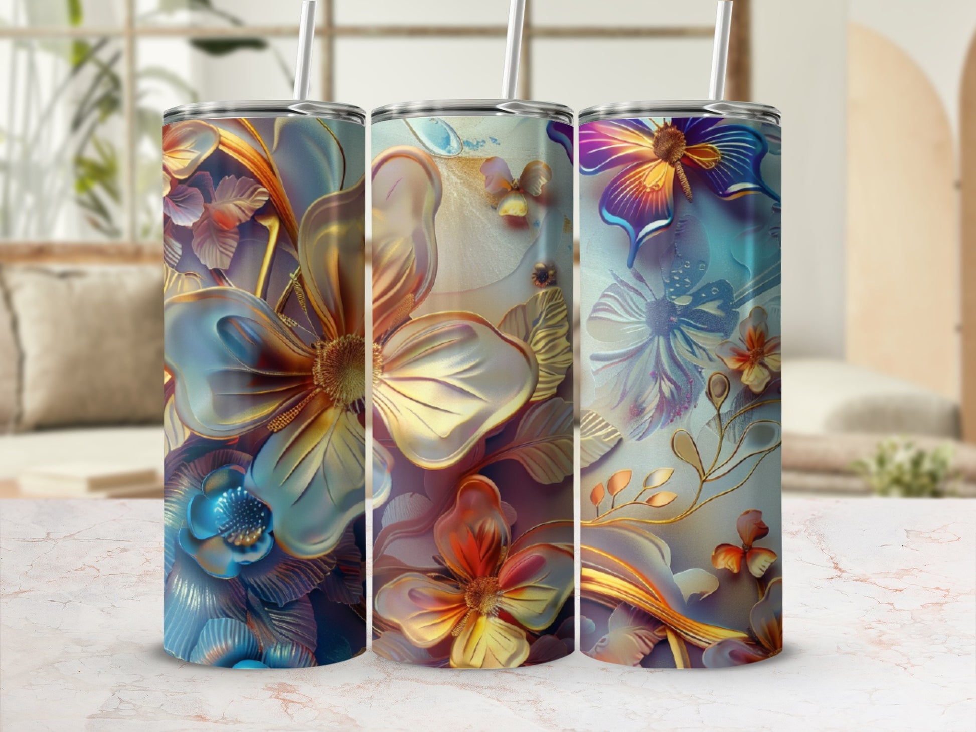 Three tumblers with floral designs in blue, gold, and purple tones.