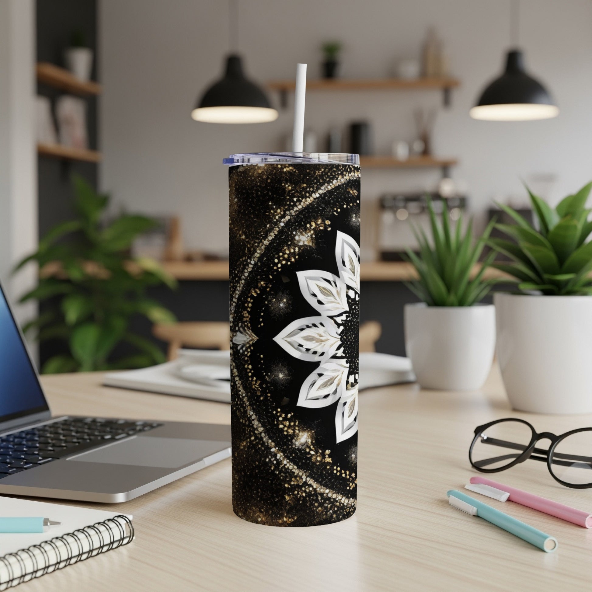 Black tumbler with white floral mandala design and glitter accents.