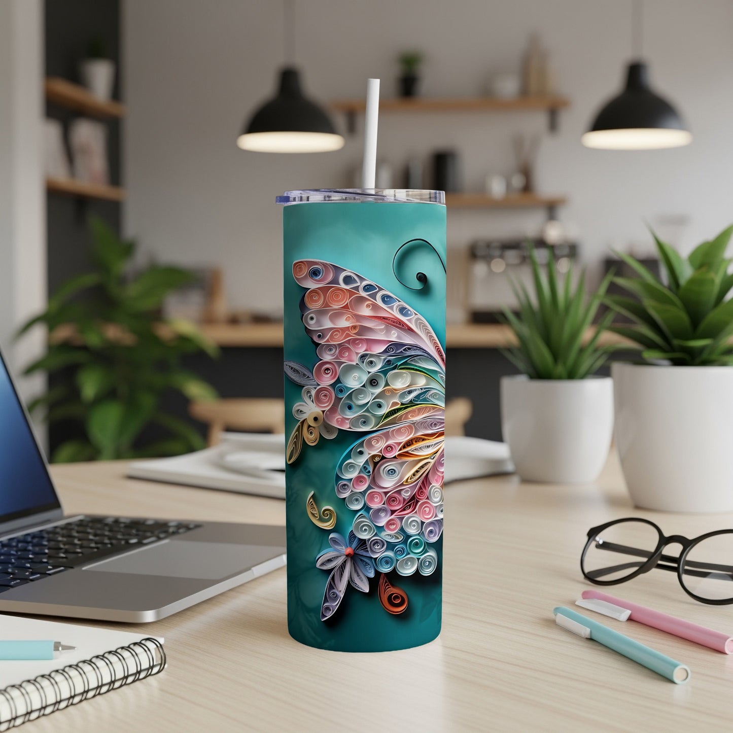 Teal tumbler with colorful quilled butterfly design and white straw.