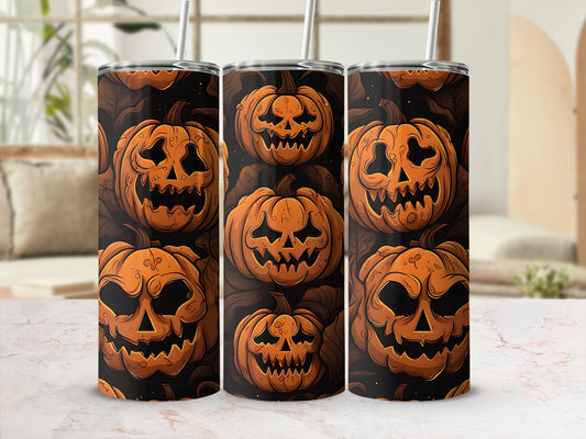 Three tumblers with a Halloween pumpkin pattern and straws.