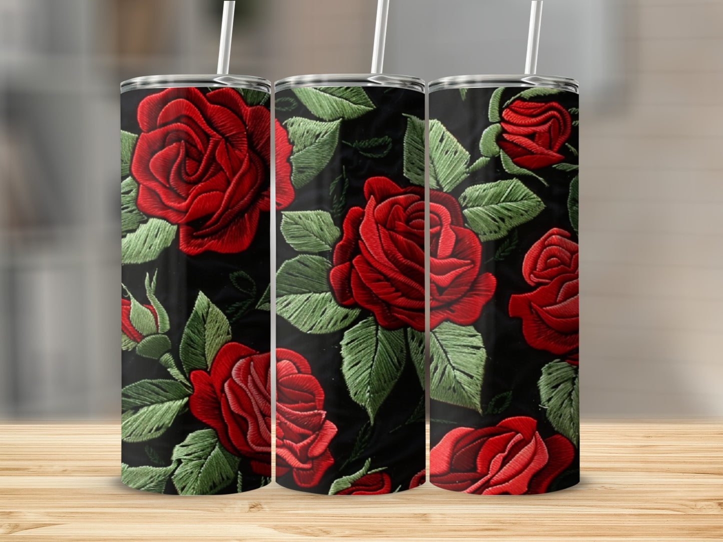 Three tumblers with a red rose floral embroidery pattern on a black background.