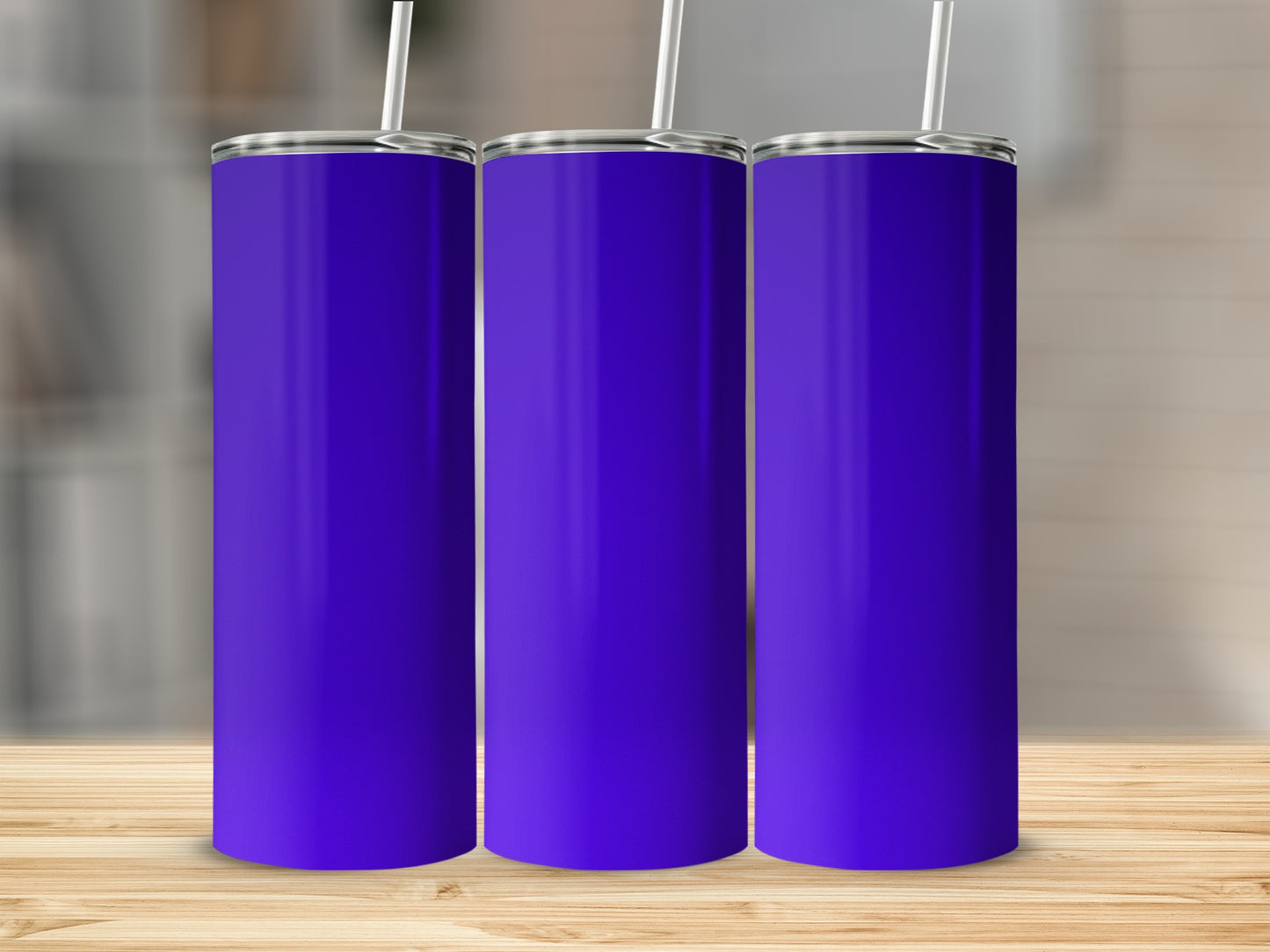 Three plain purple tumblers with white straws stand in a row.