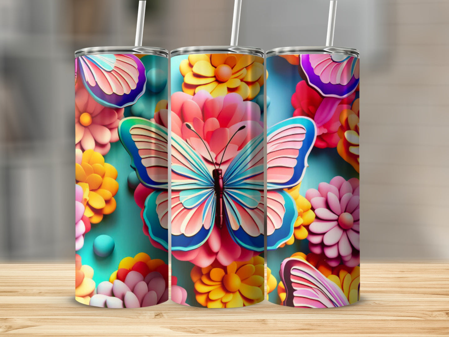 Three floral tumblers with butterflies on a wooden surface.