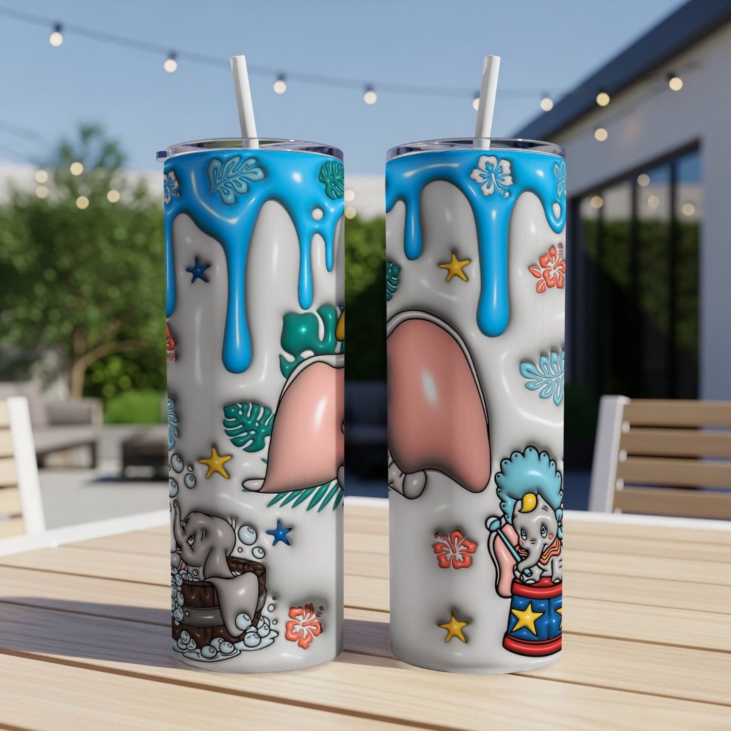 Two Dumbo themed tumblers with blue drips and elephant designs.