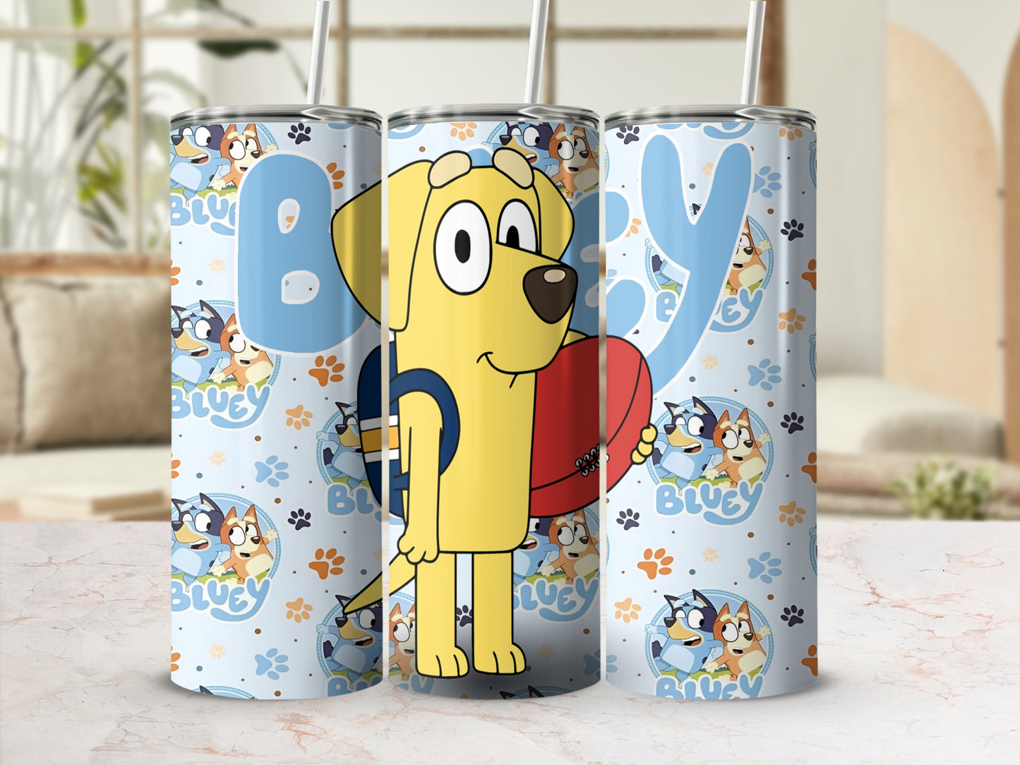 Bluey character with rugby ball on light blue tumbler with repeating Bluey pattern.