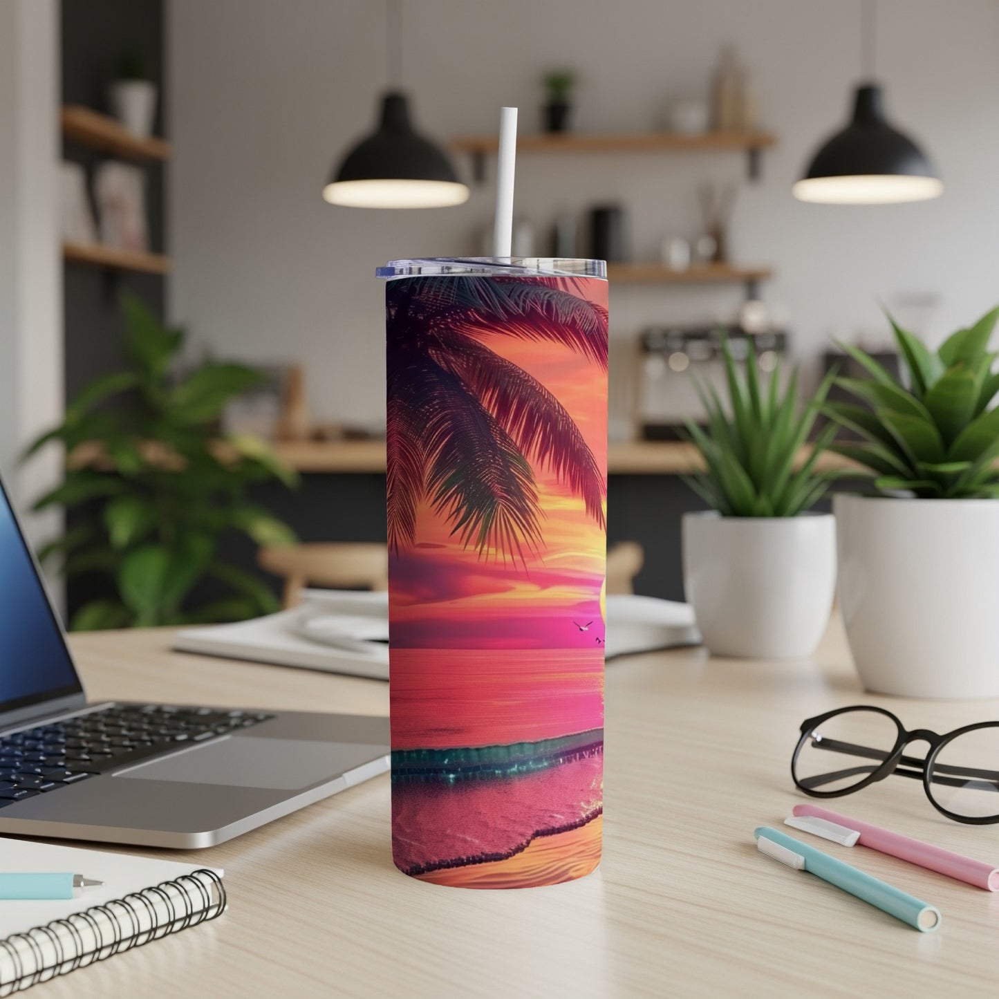 Palm tree sunset beach scene on a white tumbler with straw.