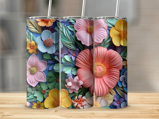 Three floral tumblers with colorful flowers and leaves on a wooden surface.