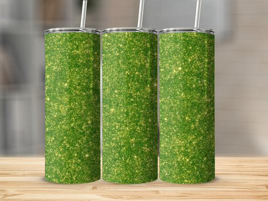 Three green glitter tumblers with white straws on a wooden surface.