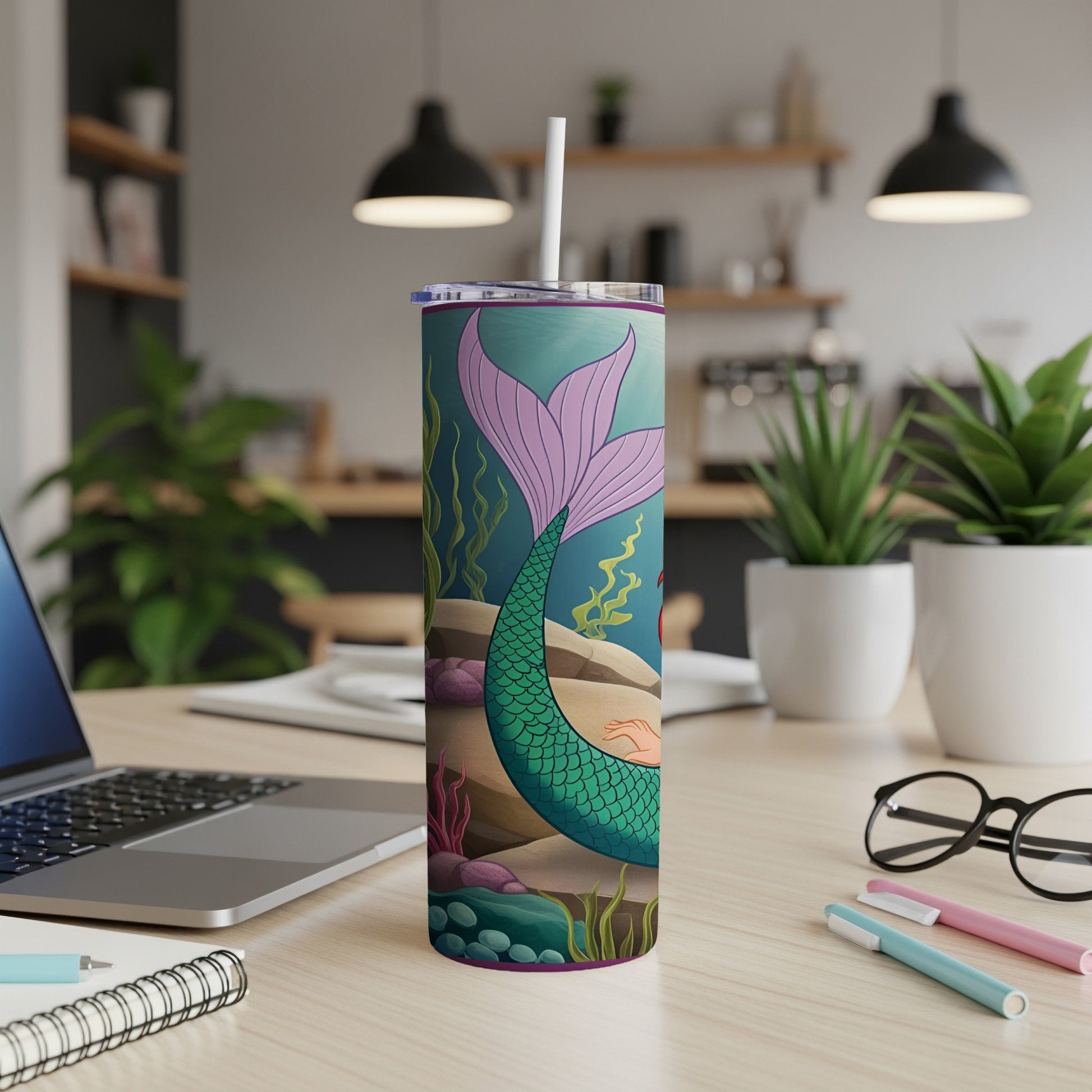 Mermaid tail and seaweed on a tumbler with a white straw.