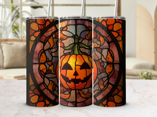 Stained glass pumpkin tumbler with jack-o'-lantern face and straw.
