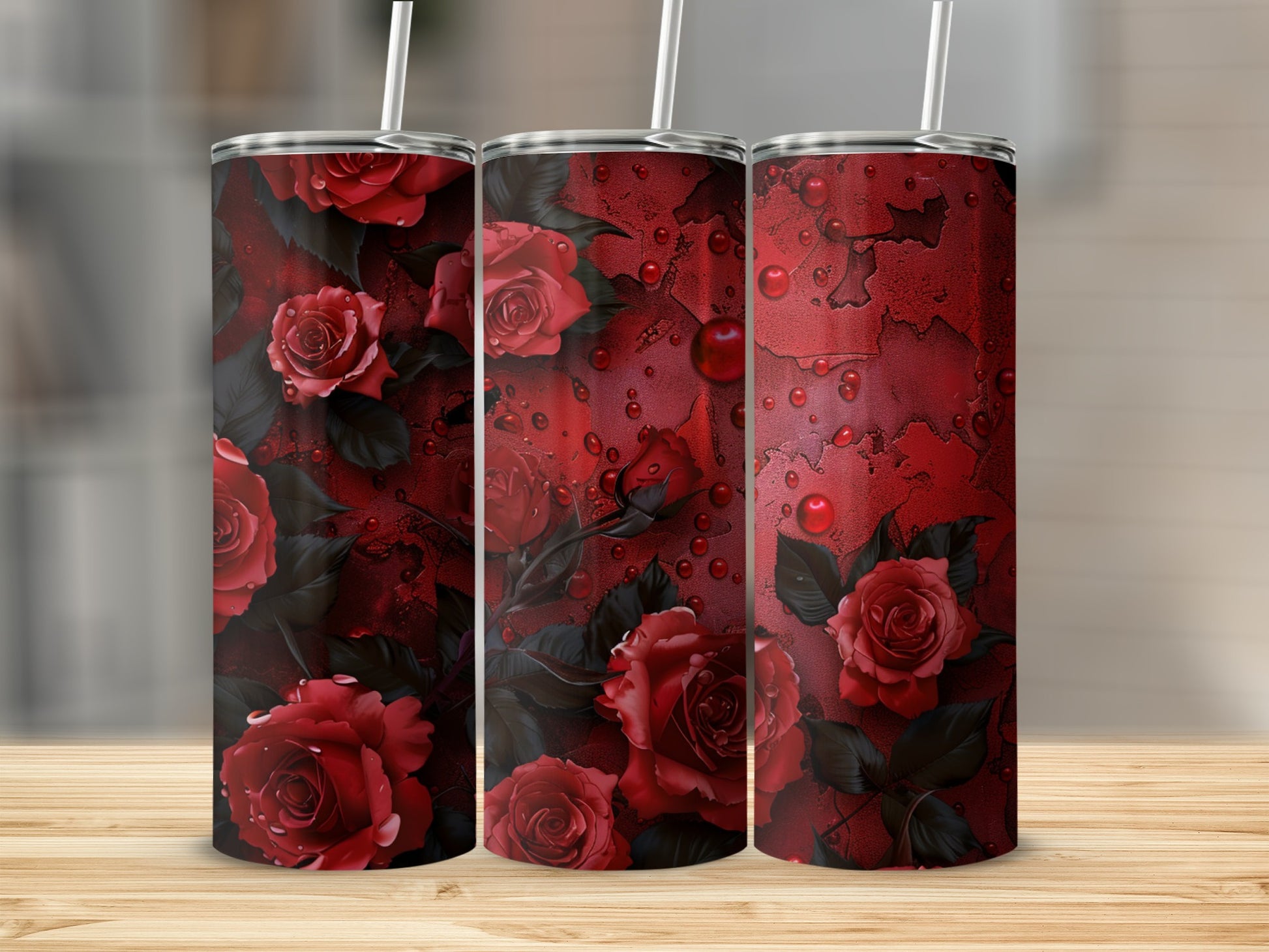 Three tumblers with red roses and water droplets on a textured red background.