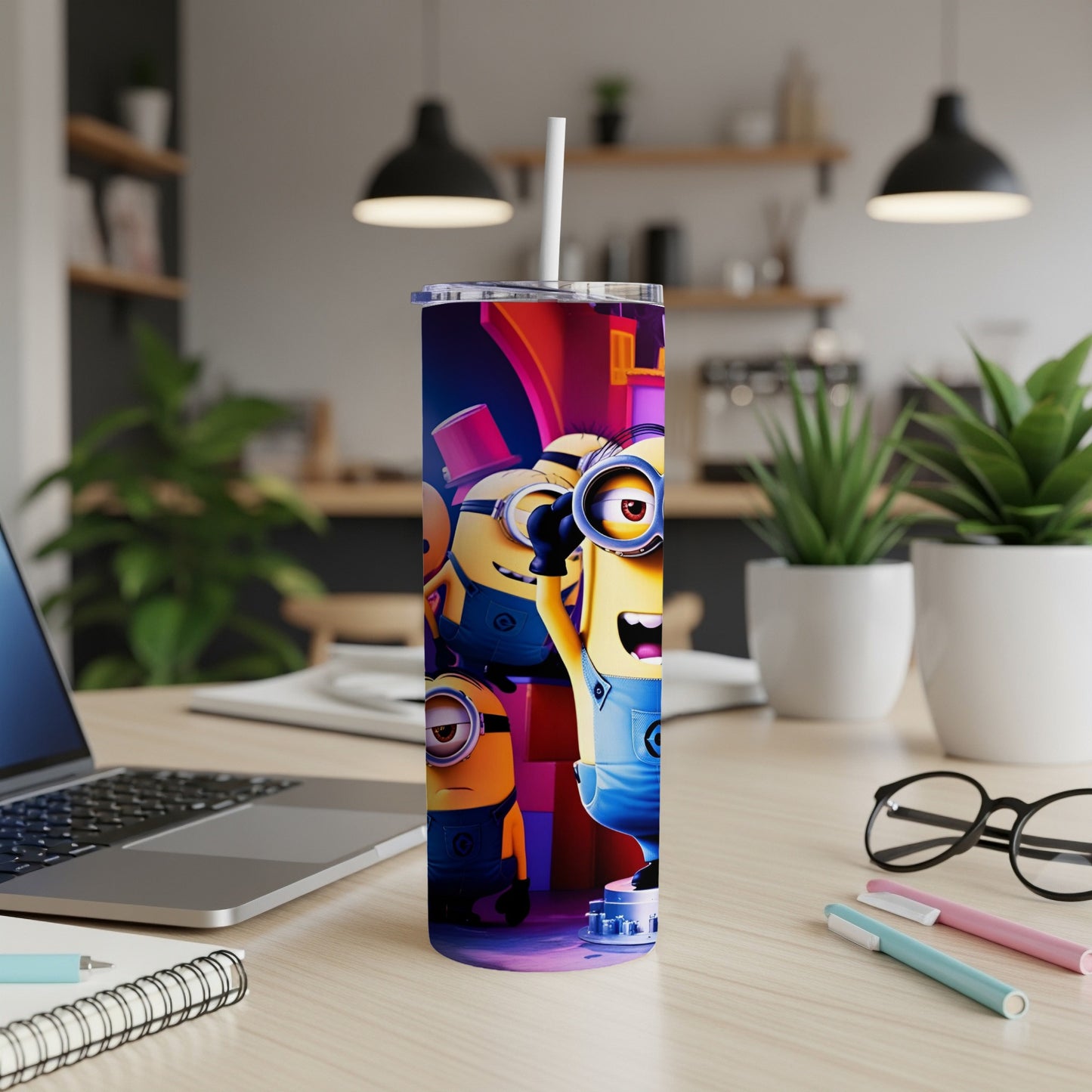 Three Minions characters on a colorful, cylindrical tumbler with a straw.