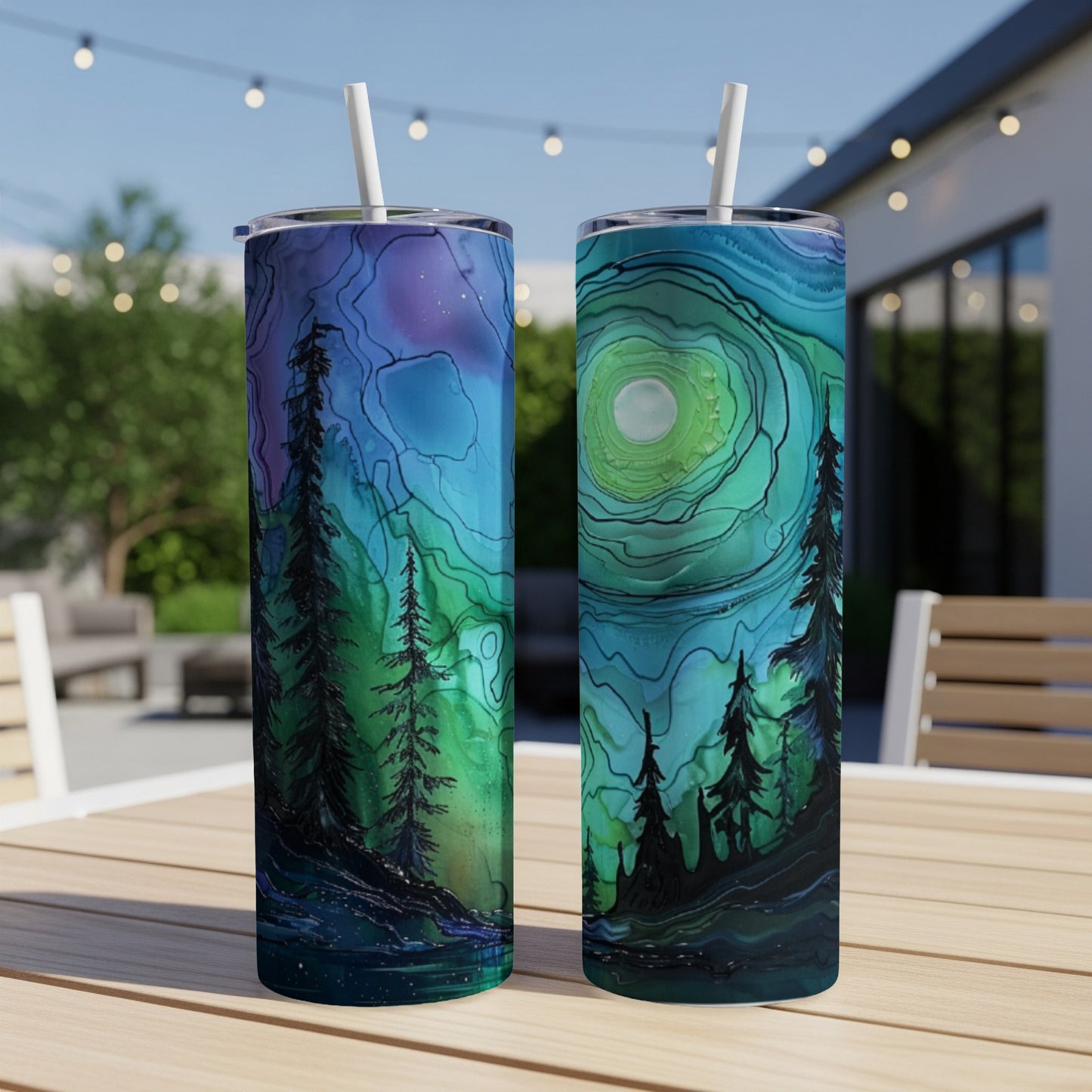 Two tumblers with a dark forest and celestial landscape design.