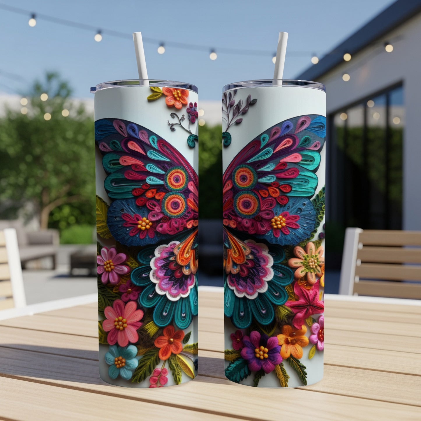 Two tumblers decorated with colorful paper butterfly and floral designs.