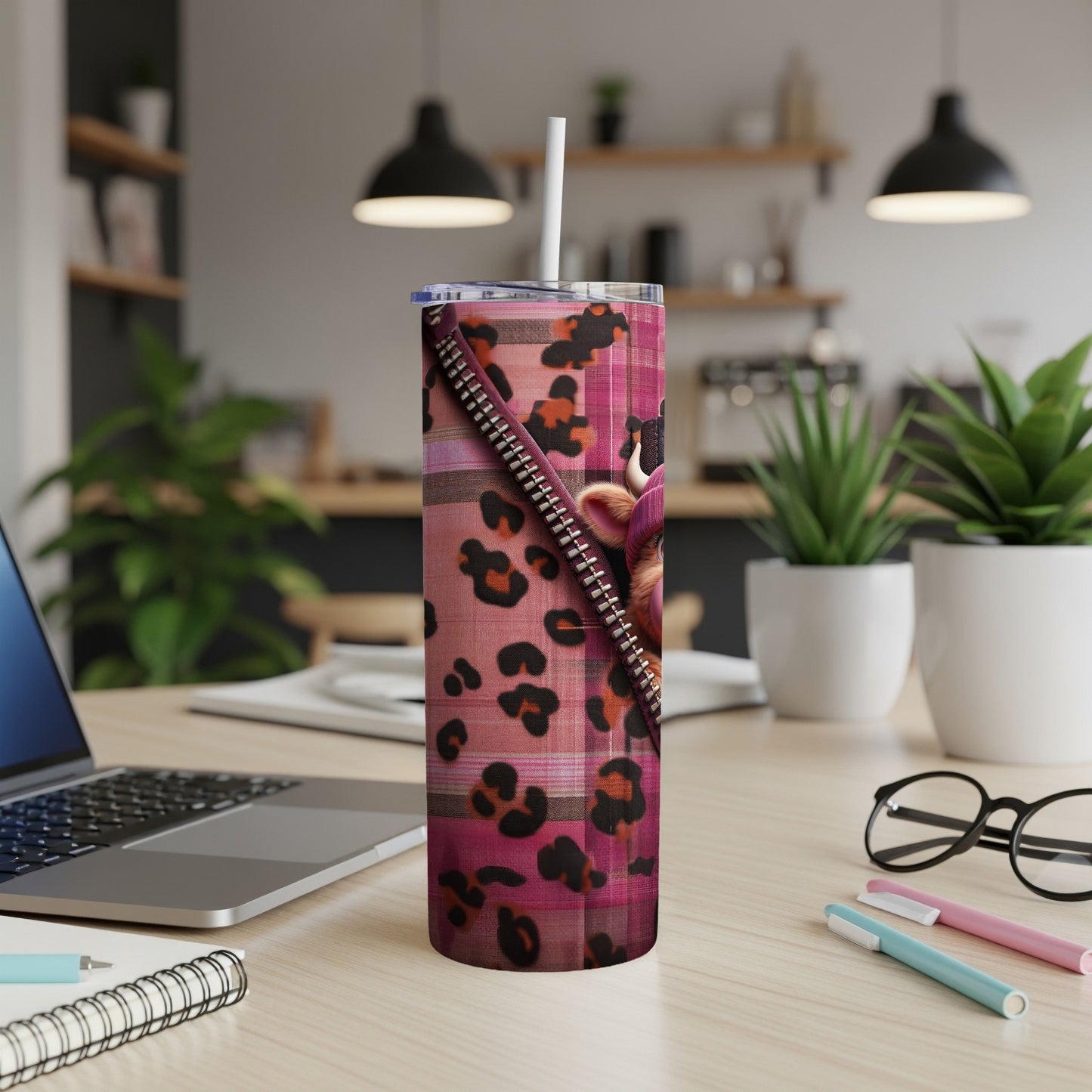 Pink cheetah print tumbler with zipper detail and straw.