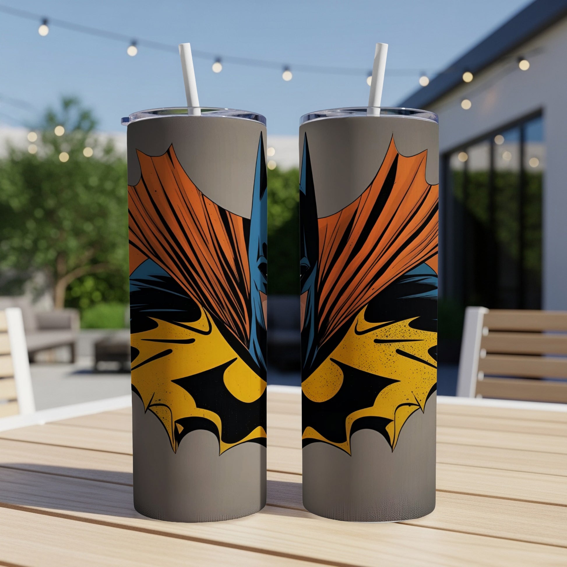 Batman cowl design on two grey tumblers with straws.