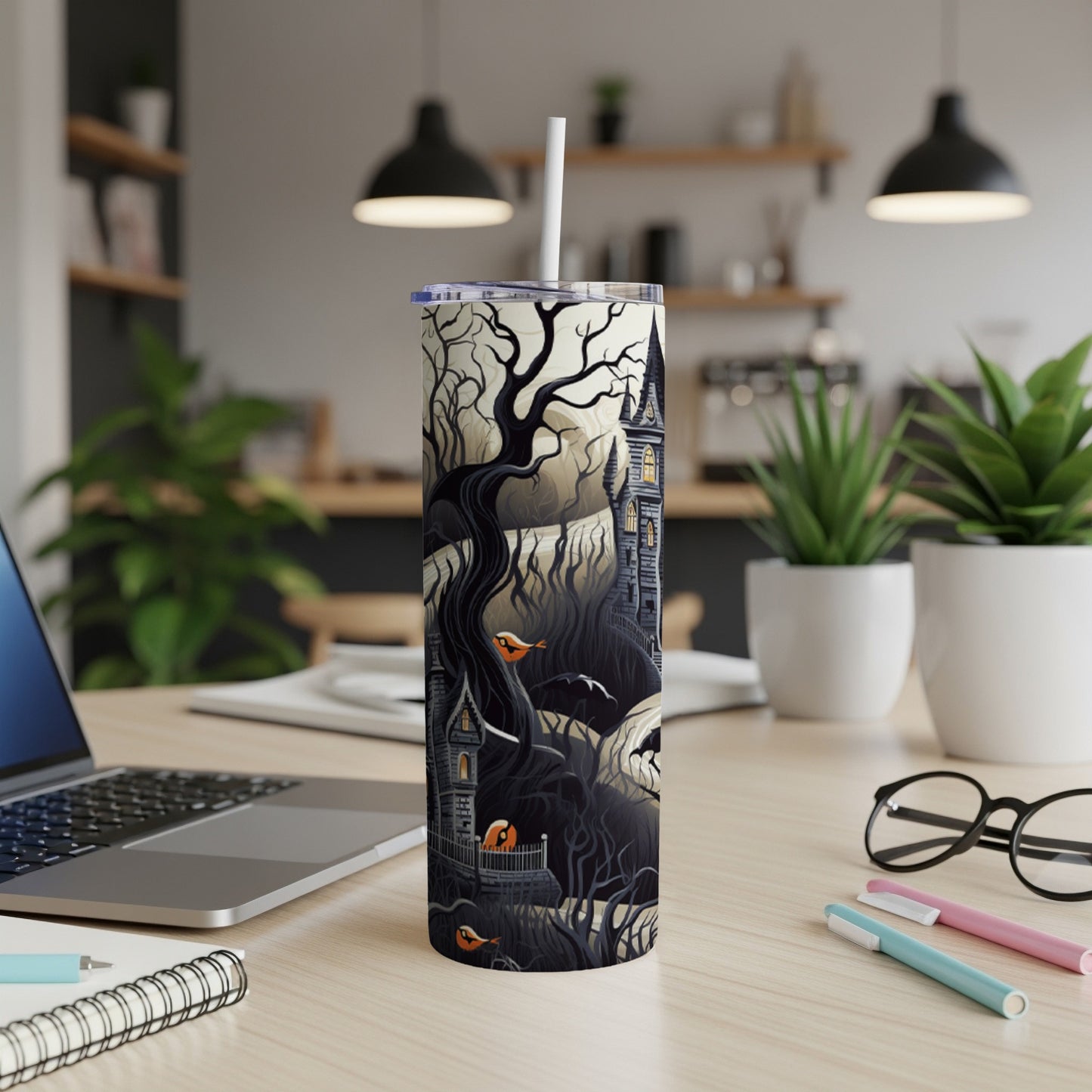 Halloween tumbler with a spooky haunted house and tree design.