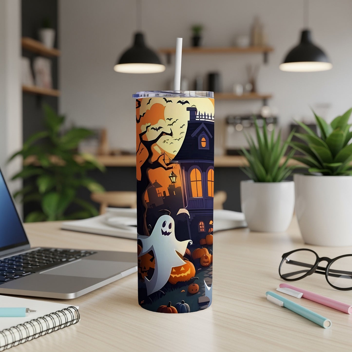 Halloween themed tumbler with ghost, haunted house, pumpkins, bats, and full moon.