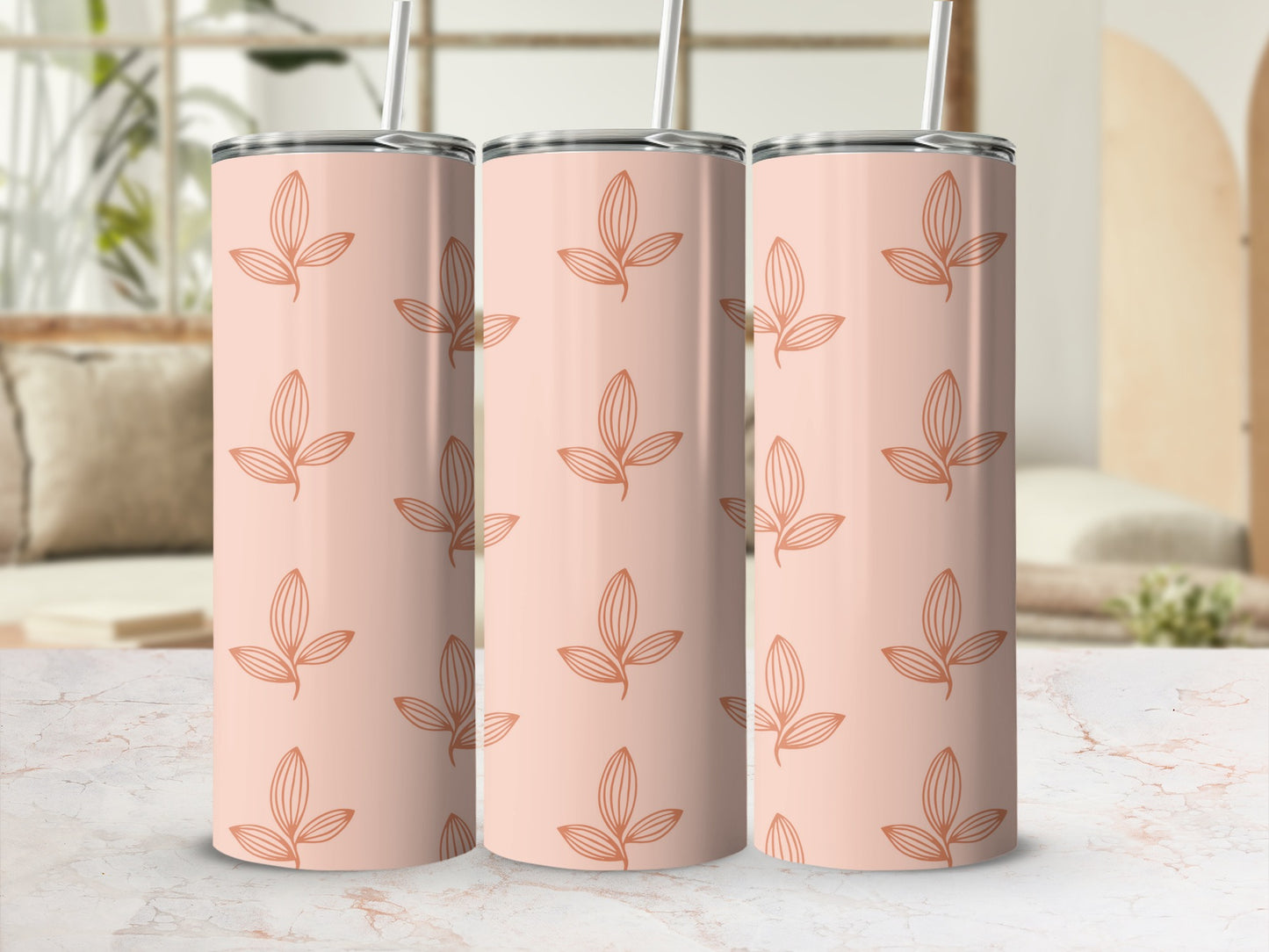 Three peach-colored tumblers with repeating leaf pattern in soft orange.