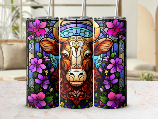 Stained glass cow portrait surrounded by purple flowers and colorful geometric patterns.