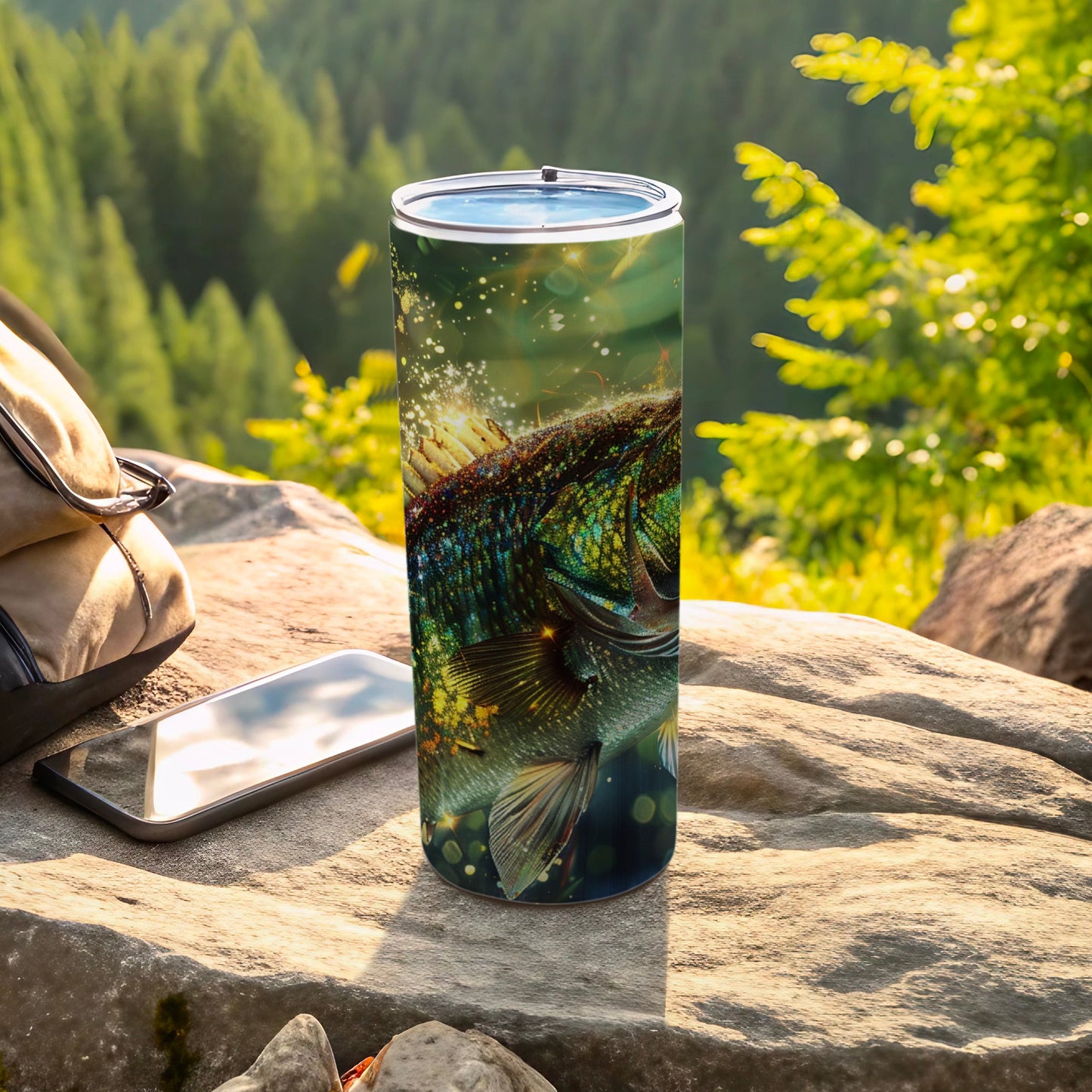 Tumbler with a detailed fish graphic, next to a backpack and phone.